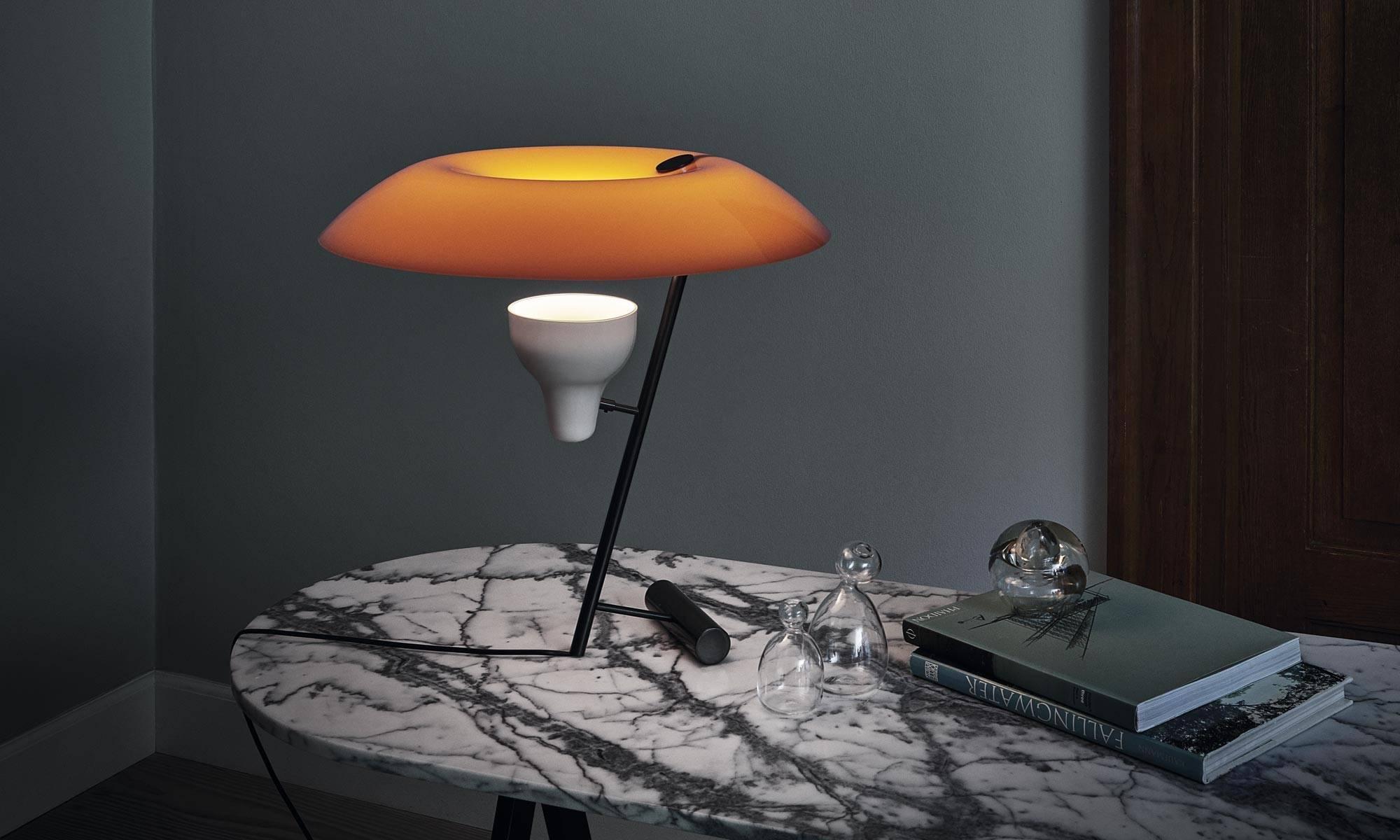 The model 548 table lamp for ASTEP was designed in 1951 by Gino Sarfatti. The lamp has an 11 watt LED in 2700 Kelvin lamp source that is dimmable with a touch dimmer. The lamp is made with a brass base in dark burnished brass and the methacrylate