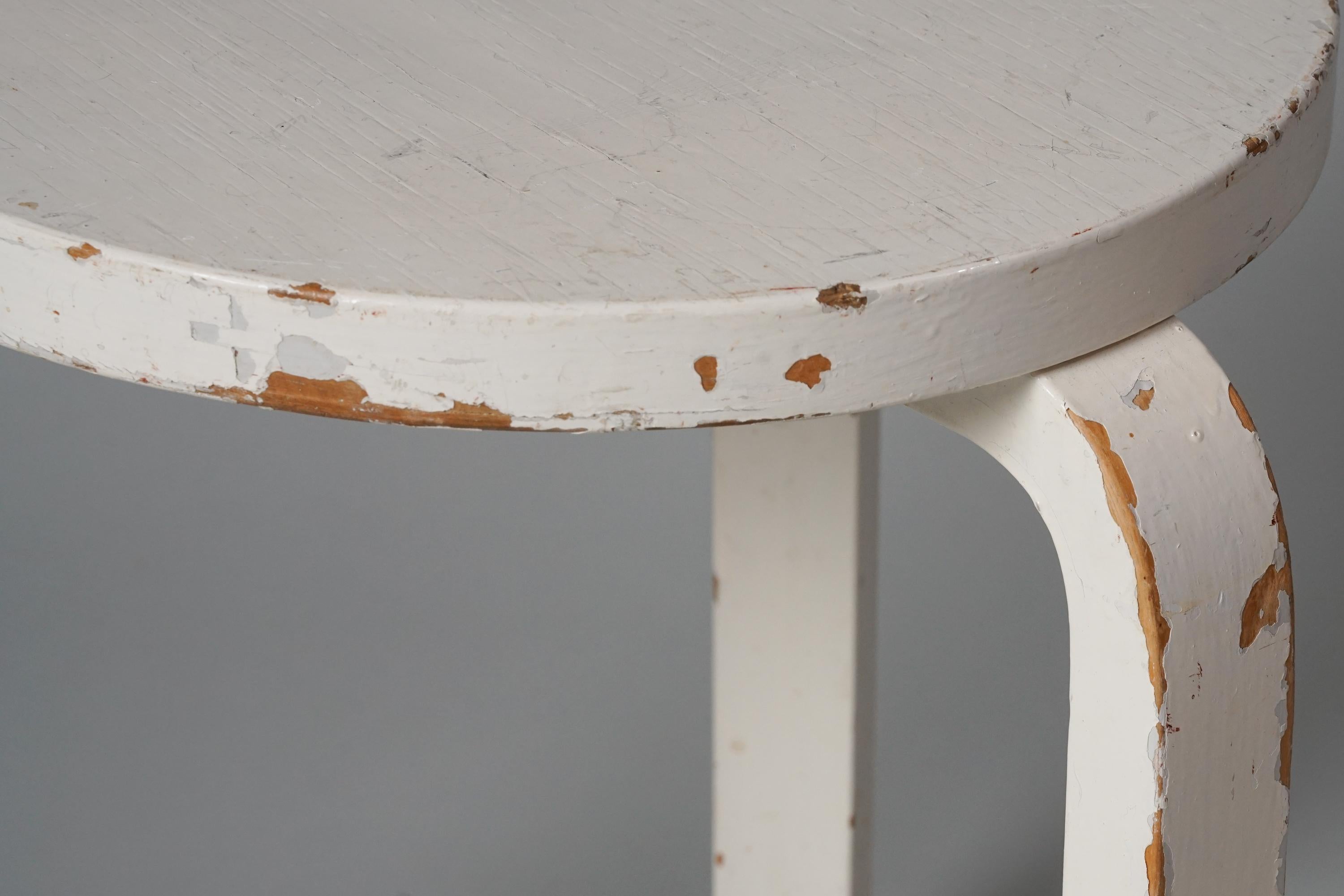 Model 60 stool, designed by Alvar Aalto, manufactured by Oy Huonekalu- ja Rakennustyötehdas Ab, 1930/1940s. Painted birch. Good vintage condition, heavy patina consistent with age and use. 

Alvar Aalto (1898-1976) is probably the most famous