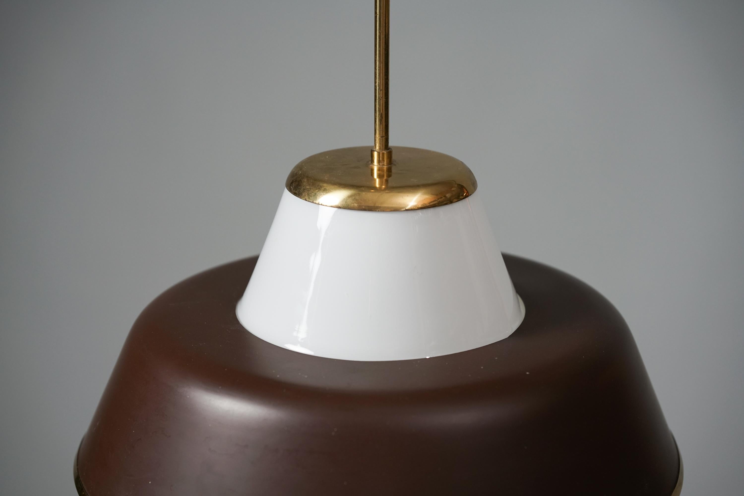Model 61-347 Pendant by Lisa Johansson-Pape for Orno Oy from the 1950s. Milk glass, brass and metal. Good vintage condition, minor patina and wear consistent with age and use. 

Lisa Johansson-Pape graduated as a furniture designer in 1927 and had a