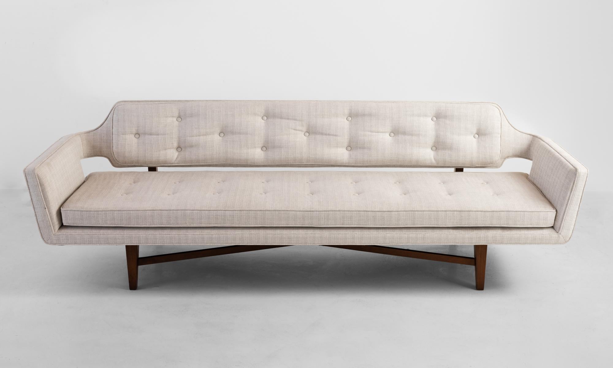 Model 6133 sofa by Edward Wormley, America, circa 1960.

Original upholstery with subtle tonal striping on cross bar wooden base.
