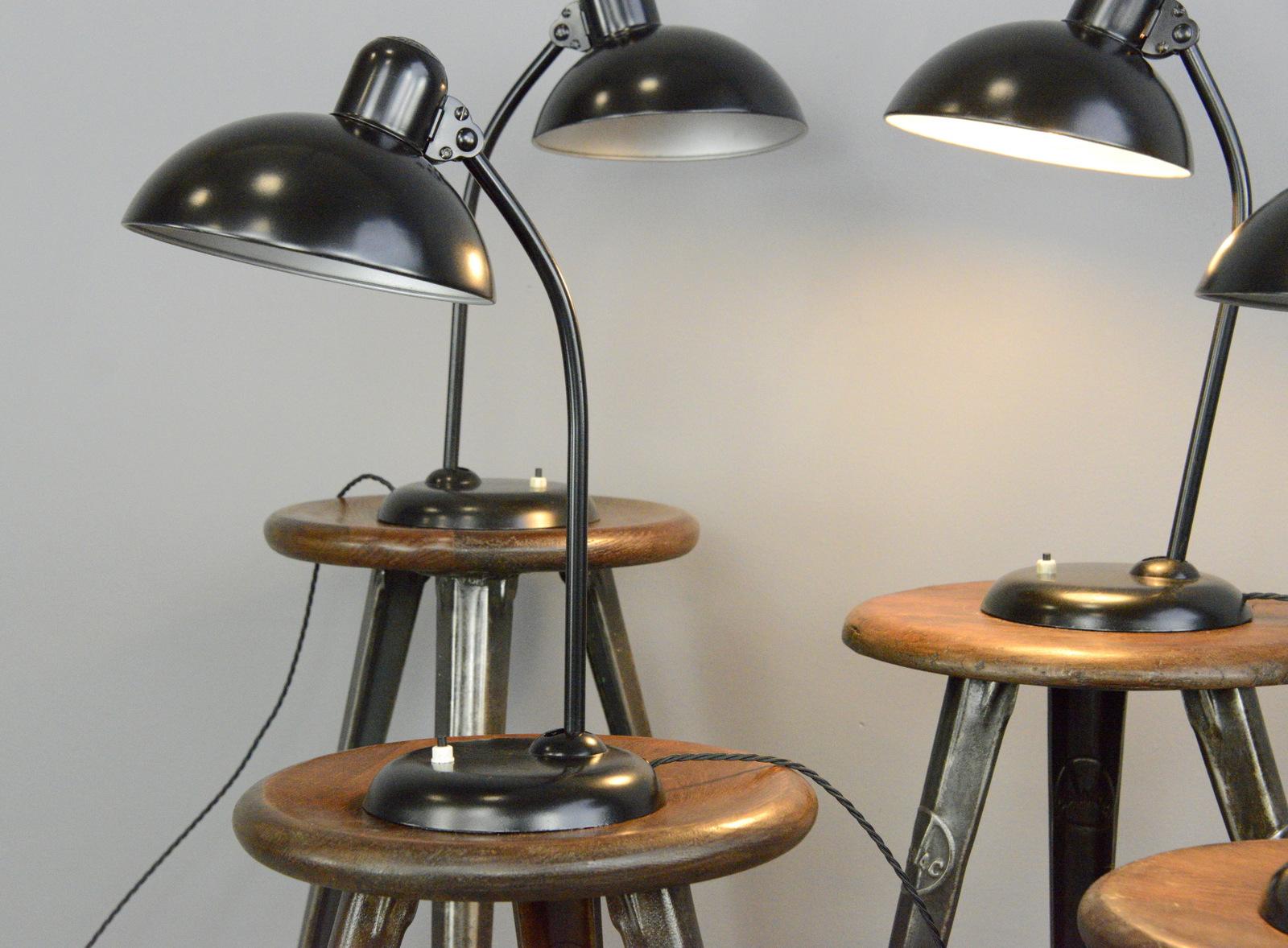 Model 6556 table lamps by Kaiser Idell, circa 1930s

- Price is per lamp (4 available)
- Steel shade with relief Kaiser Idell branding
- On/Off switch on the base
- Takes E27 fitting bulbs
- Adjustable arm and shade
- Designed by Christian