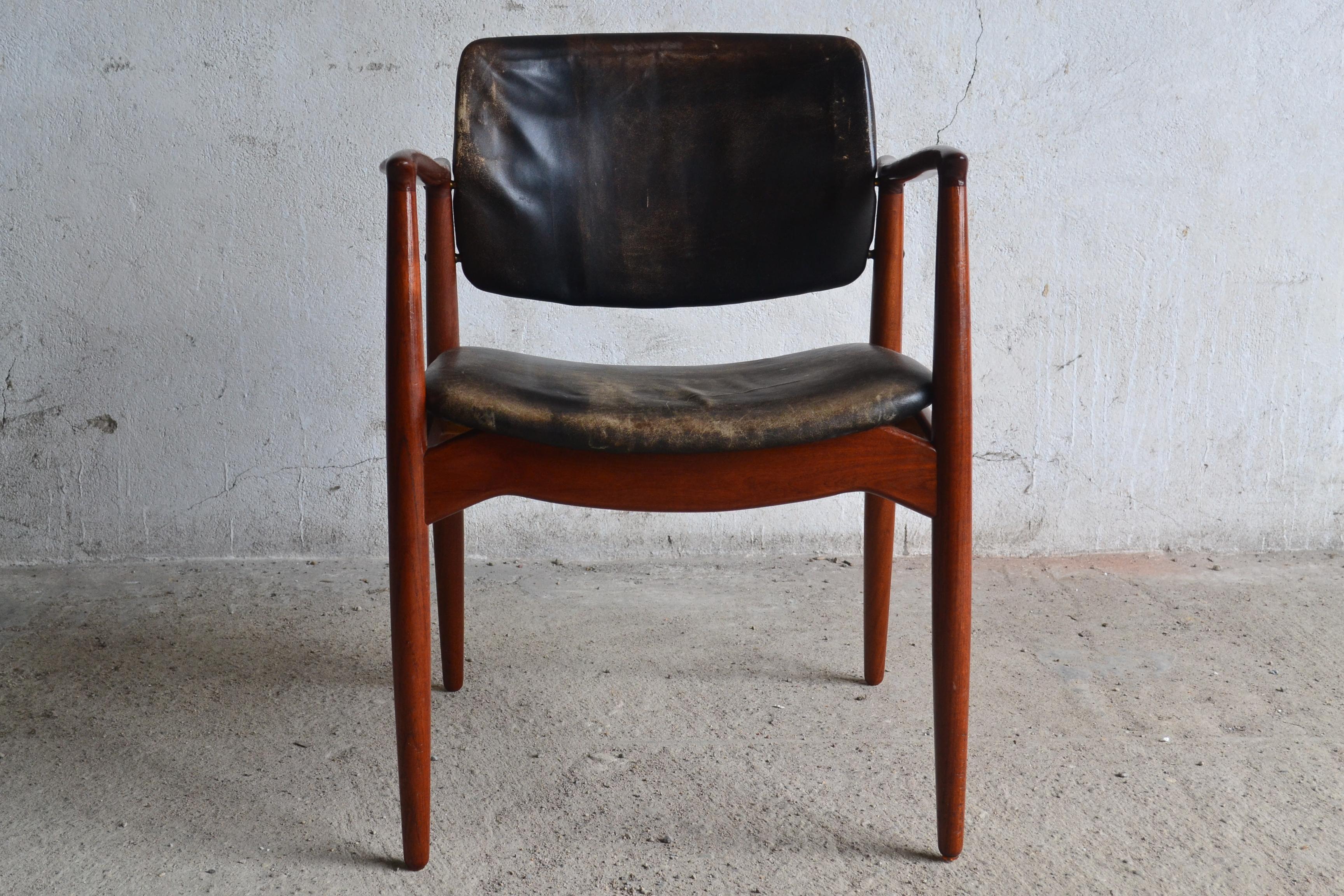 This model 67 armchair was designed by Erik Buch in the 1960s and is in original condition with no tears and cracks.
