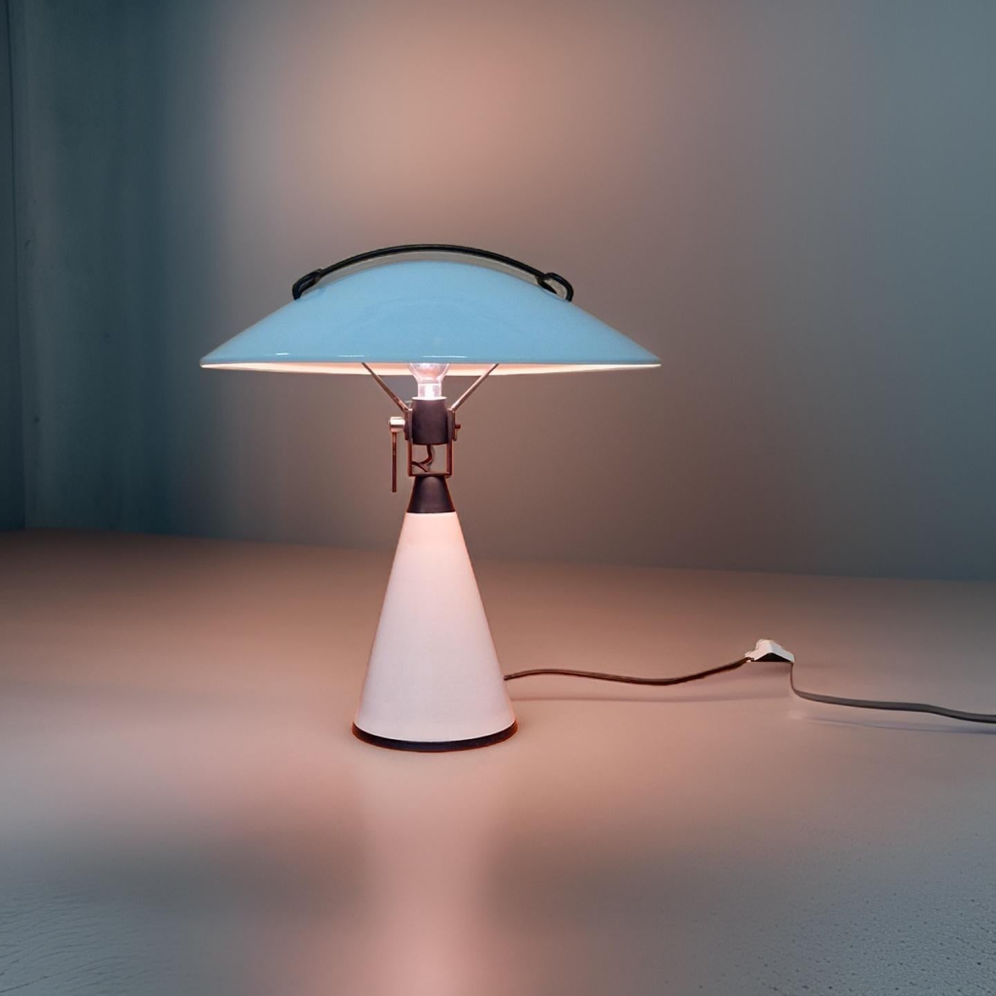 Impressive floor or table lamp. Designed by Elio Martinelli for Martinelli Luce in the 1970s. It is made from metal. The satellite dish shaped shade can rotate and pivot so it can reflect the light in different directions. 

Martinelli Luce was