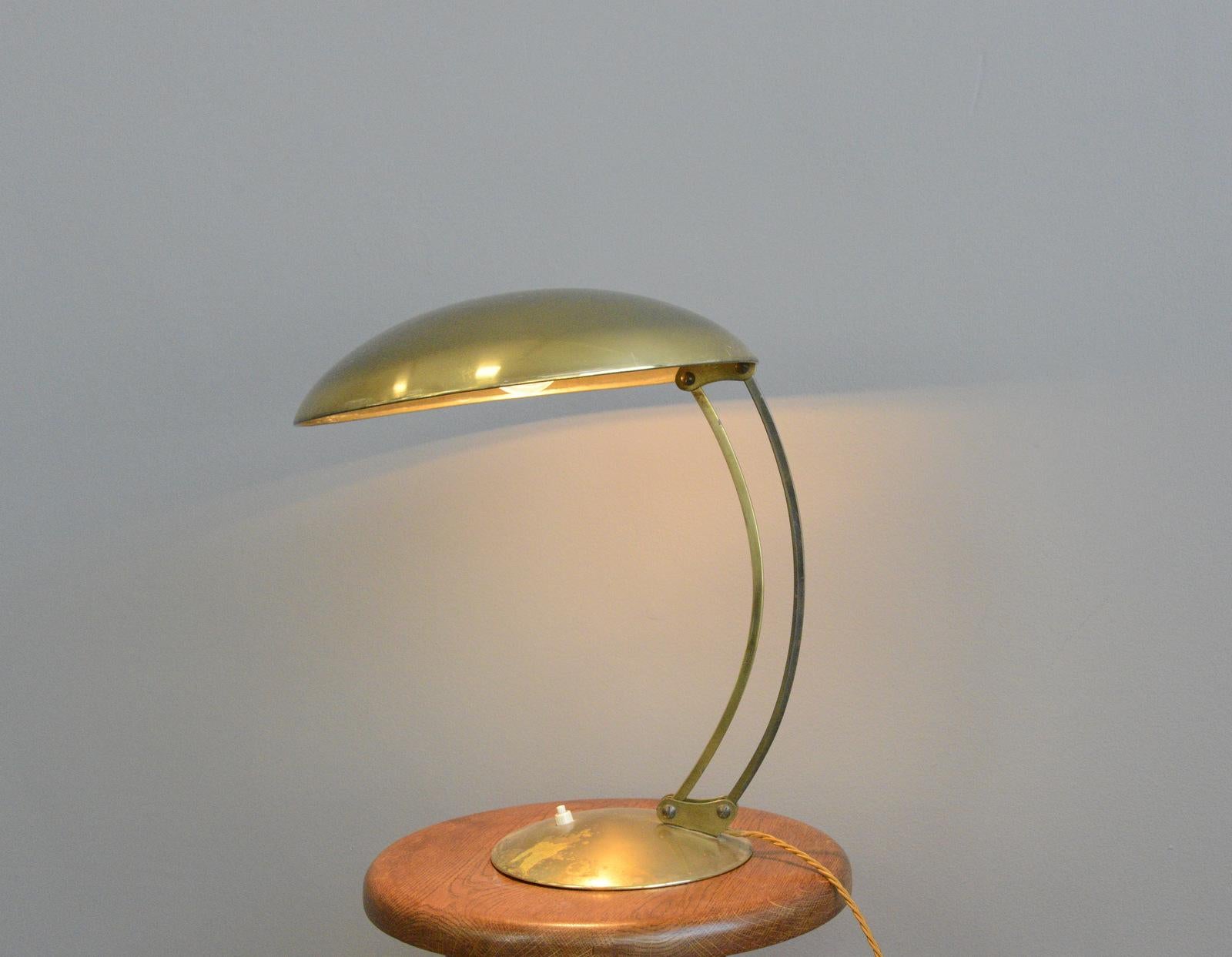Model 6764 brass table lamp by Kaiser Idell, circa 1940s.

- Solid brass shade and arms
- Brass base with cast iron insert
- Inline switch on the bases
- Adjustable arms
- Designed by Christian Dell for Kaiser Idell
- German, 1940s
-