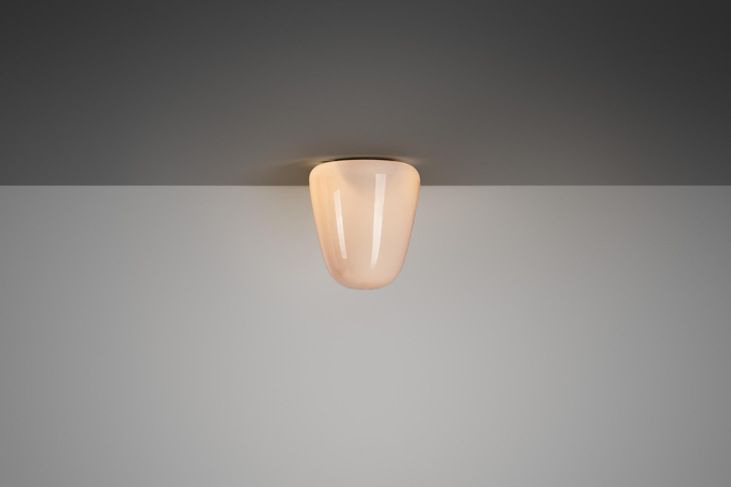 Finnish mid-century design was derivative of a traditional aesthetic with a modern sensibility, mixed with an extensive use of glass and brass as material. This especially rare flush mount has been documented to have once graced the Helsinki Home