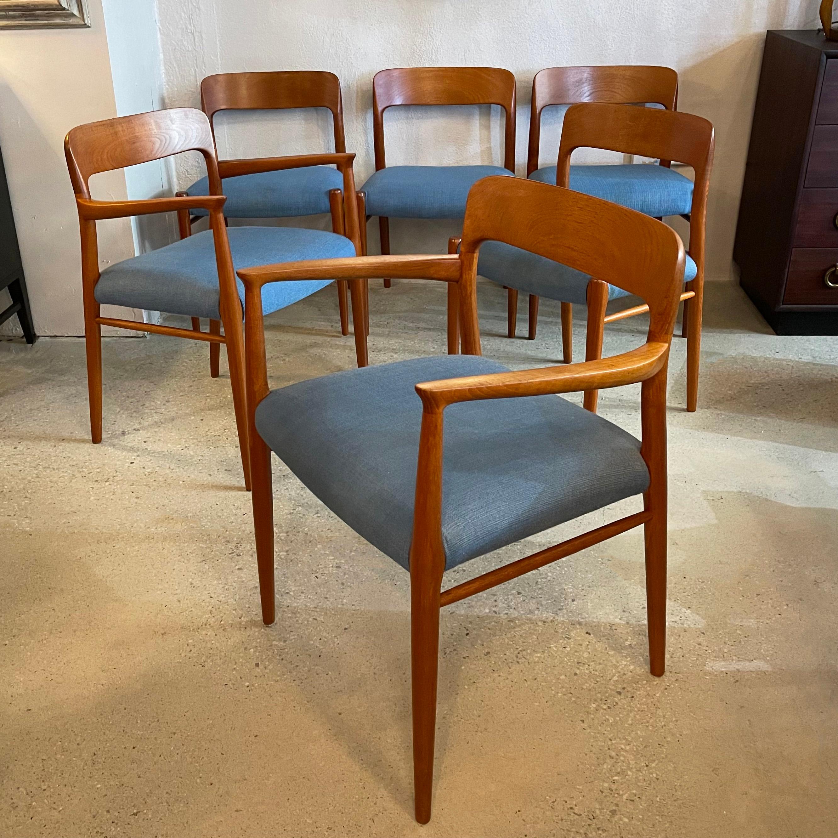 Set of six Scandinavian modern, model 75, teak dining chairs by Niels O Møller for J.L. Møllers Møbelfabrik consist of four side chairs and 2 captain armchairs. The rich honey tone teak frames contrast beautifully with the azure blue, linen blend,
