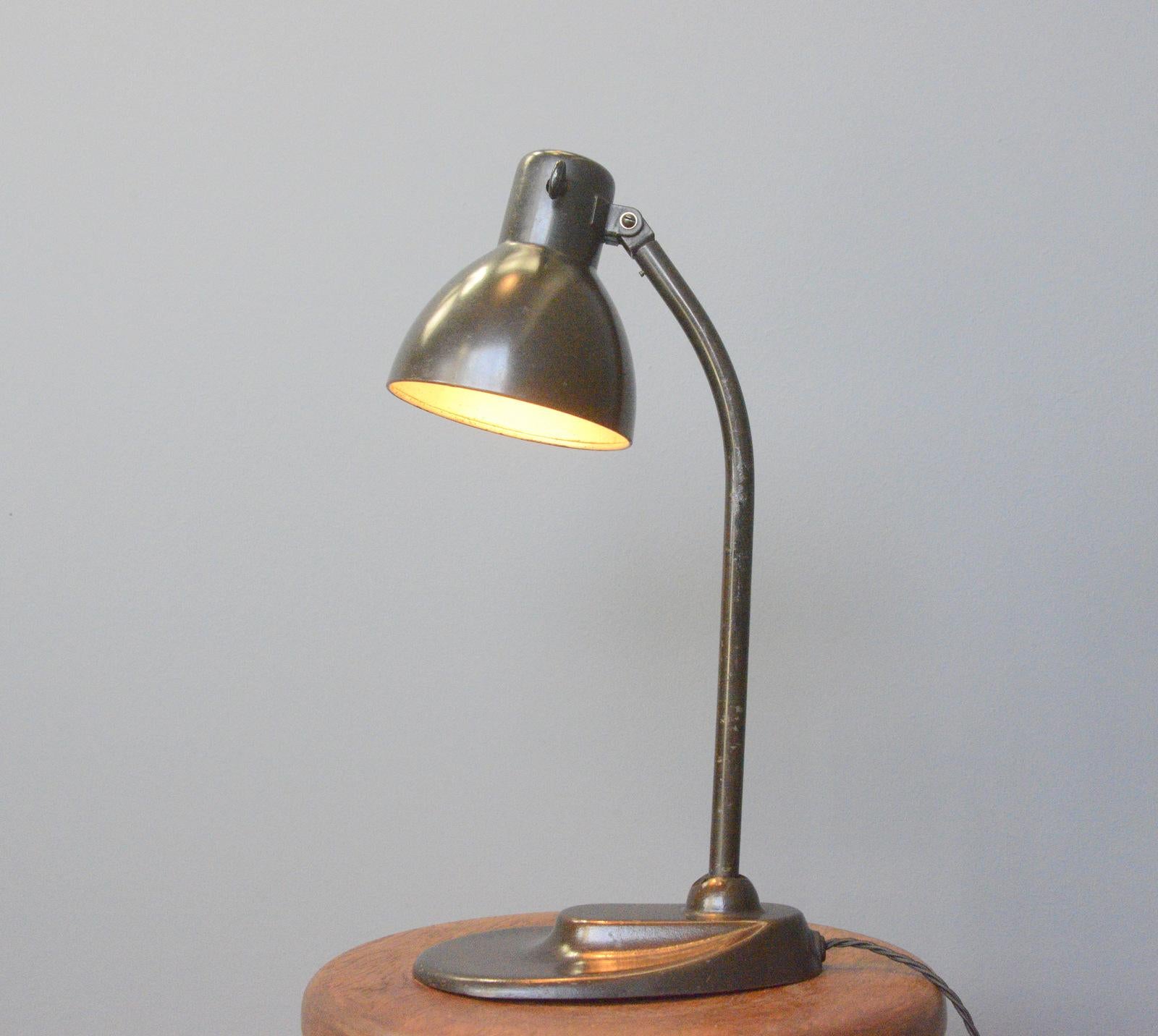 Model 752 table lamp by Kandem Circa 1930s.

- Original brown paint
- Cast iron foot with curved steel arm
- Adjustable shade and arm
- Original bakelite On/Off toggle switch
- Takes E27 fitting bulbs
- Designed by Hin Bredendieck & Hermann