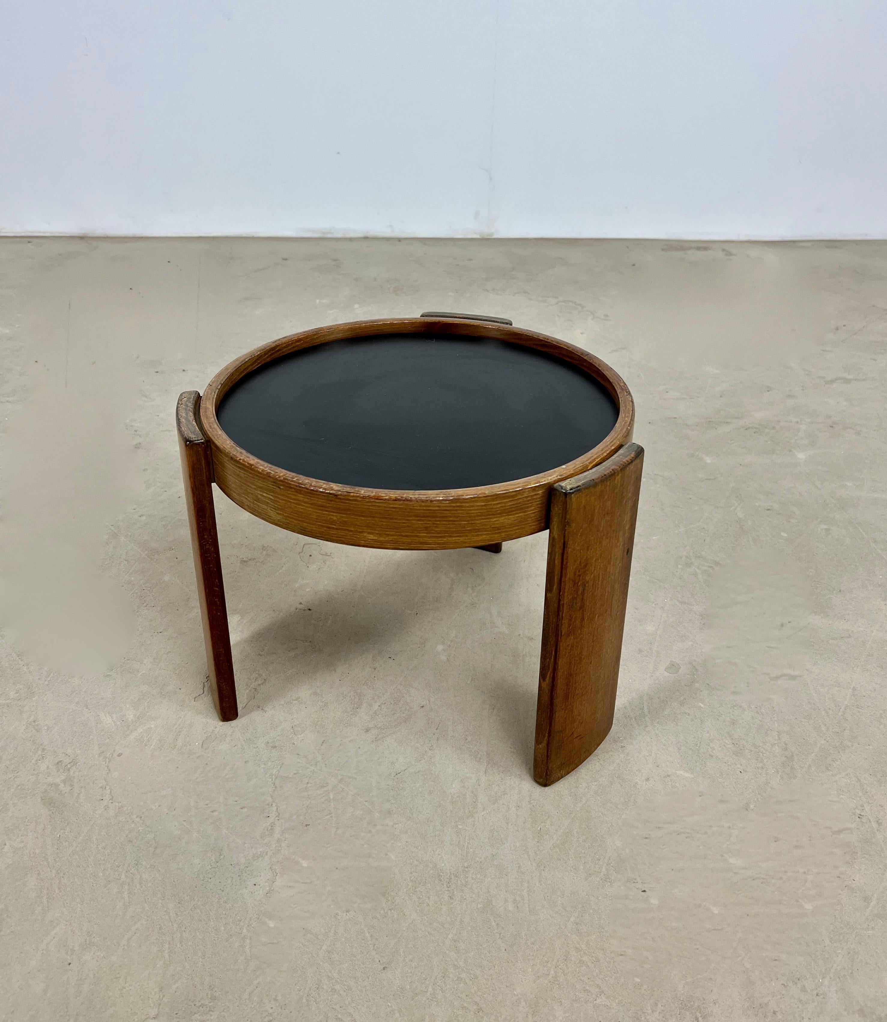 Wooden table. Reversible black and white table top. Wear due to time and age of the table.