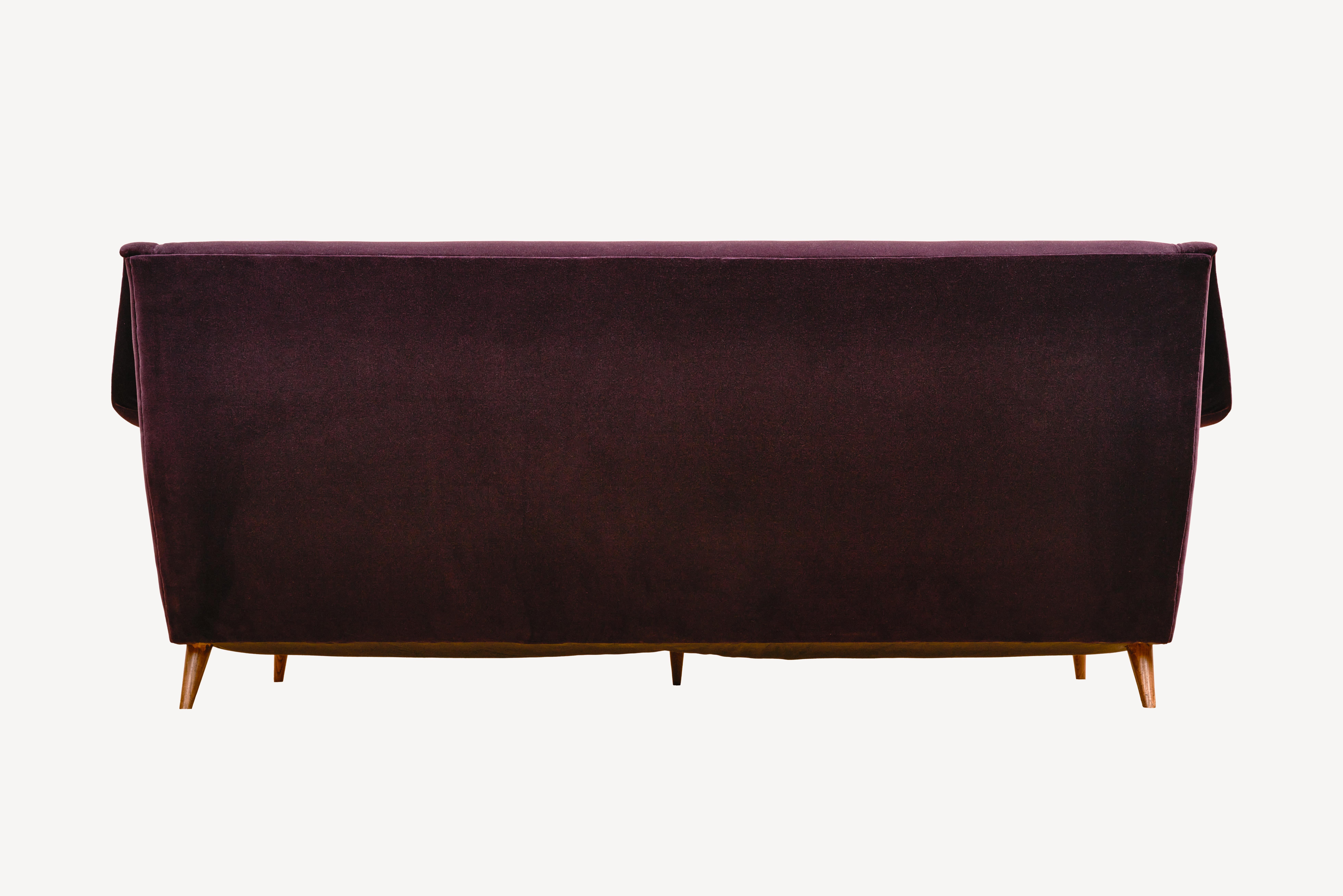 The Model 802 Sofa designed by Carlo de Carli is a stunning piece of mid-century modern furniture that is highly sought after by collectors and design enthusiasts. The sofa features a sleek and minimalist design, with clean lines and a low profile