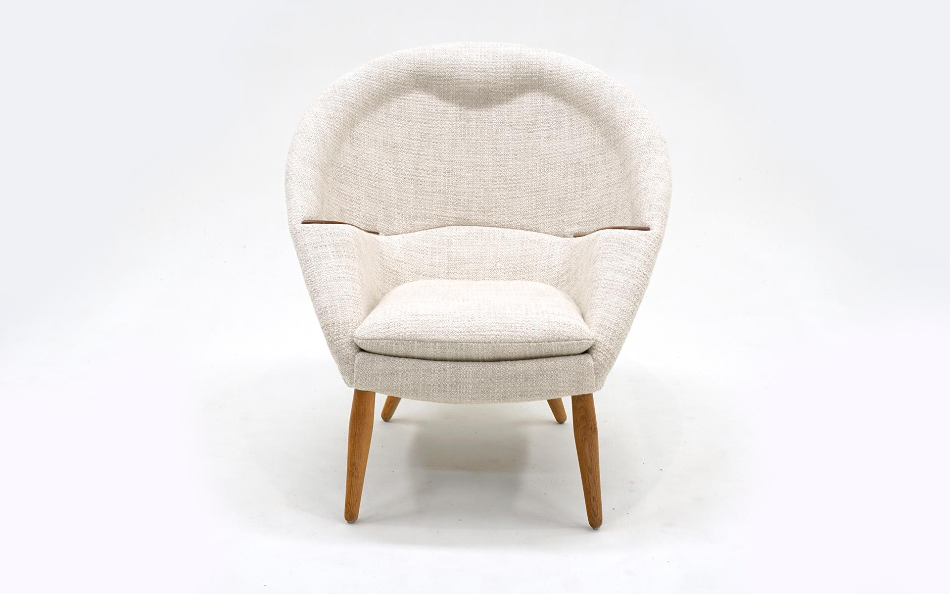 Original and restored  Model 9 Lounge Chair created by Arnold Madsen, Denmark, 1956,  features a complex horseshoe construction with an integrated headrest and beautifully incorporated armrests in wood. Offering comfortable support, the embracing