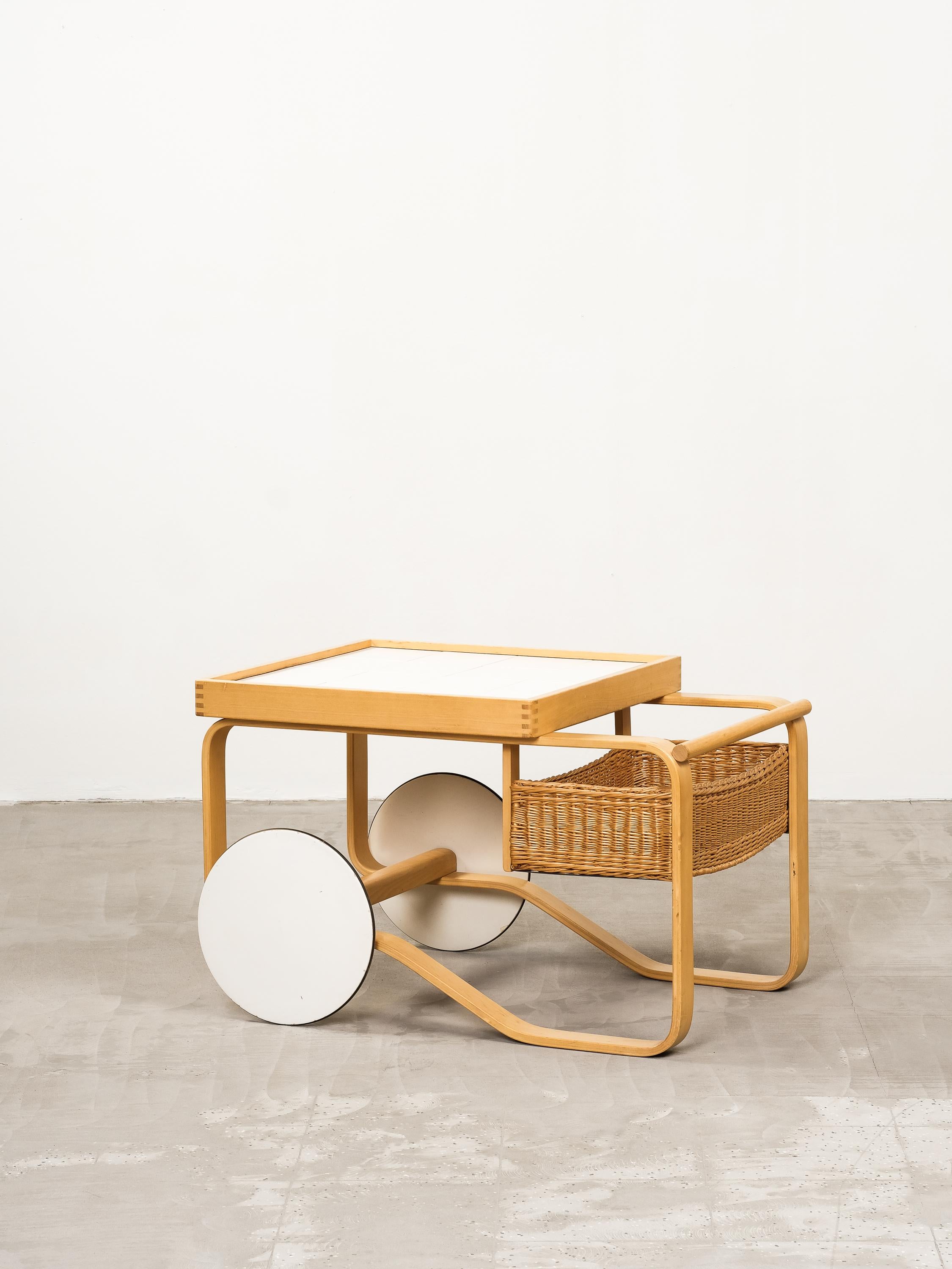Chariot à thé vintage Alvar Aalto modèle 900 fabriqué dans les années 1960 en Finlande. Carreaux en céramique blanche et panier en rotin tressé. La boîte en rotin est d'origine et présente quelques taches foncées qui ne font qu'ajouter au caractère