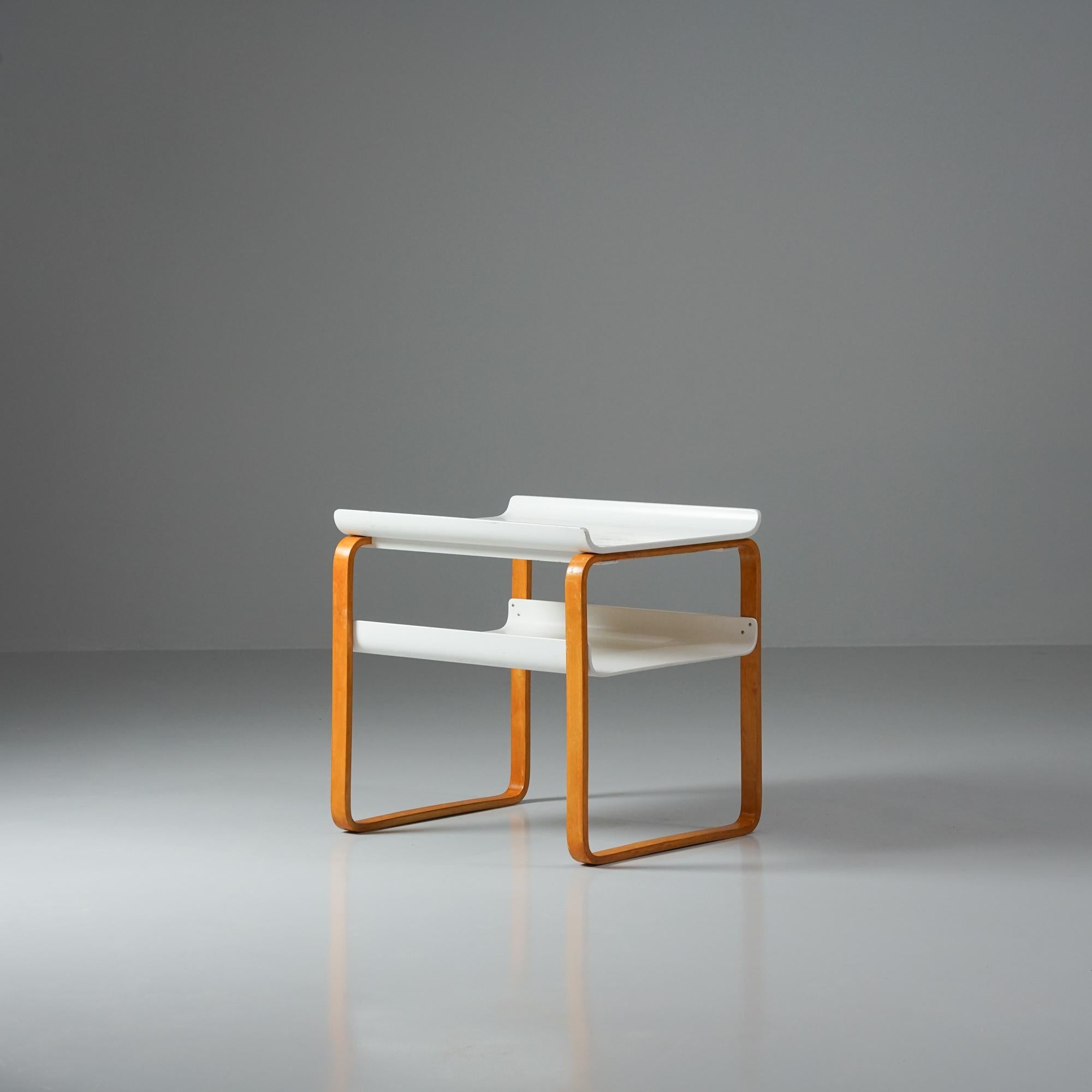 Model 915 side table, designed by Alvar Aalto, manufactured by Artek, 1950/1960s. Beautiful honey colored patinated birch legs with white painted table tops. Good vintage condition, patina and minor wear consistent with age and use. Alvar Aalto