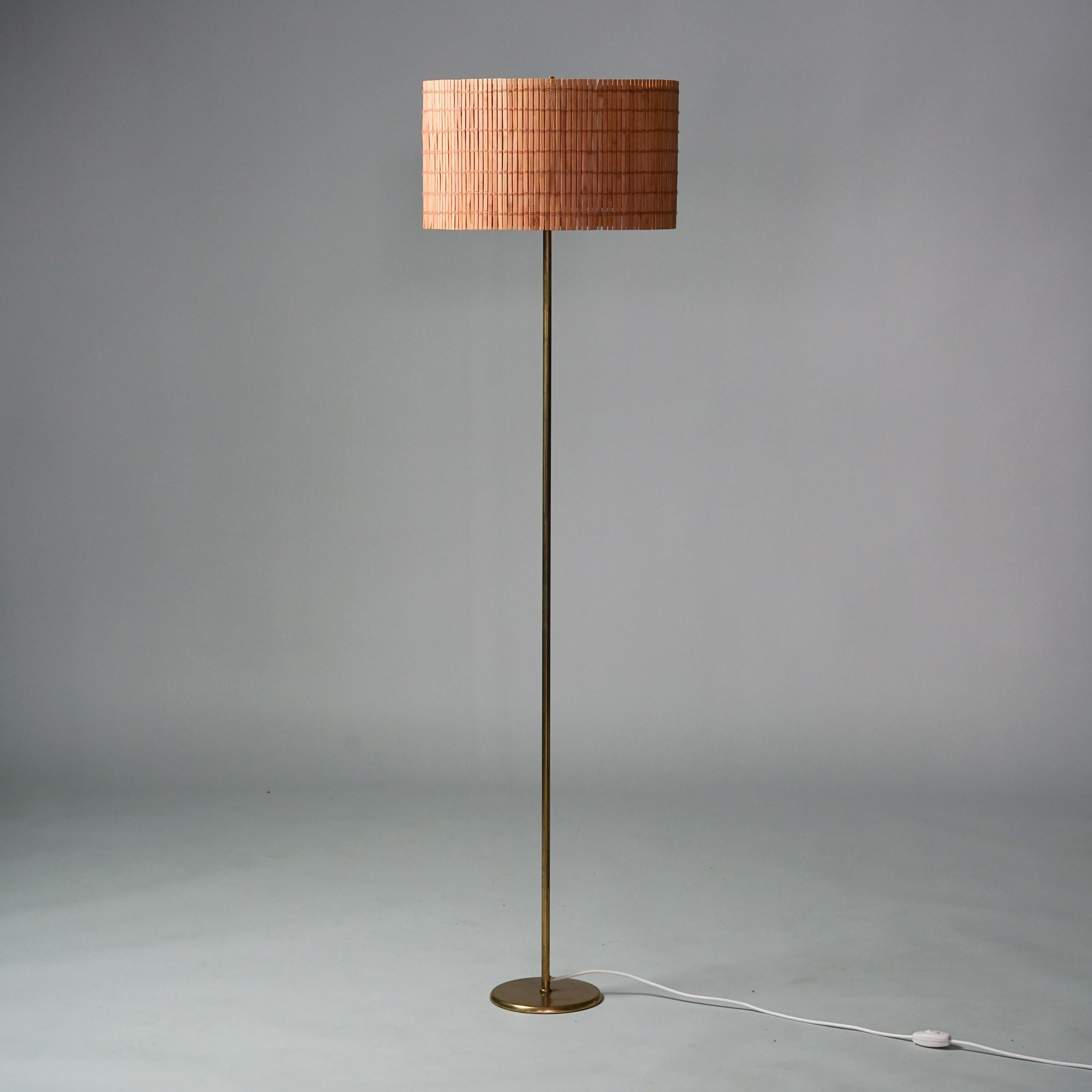 Model 9633 floor lamp, designed by Paavo Tynell, manufactured by Taito Oy, 1940/1950s. Brass frame with handmade wooden slat shade. Good vintage condition, minor patina consistent with age and use. Stamped Taito Oy.

Paavo Tynell (1890-1973) is one
