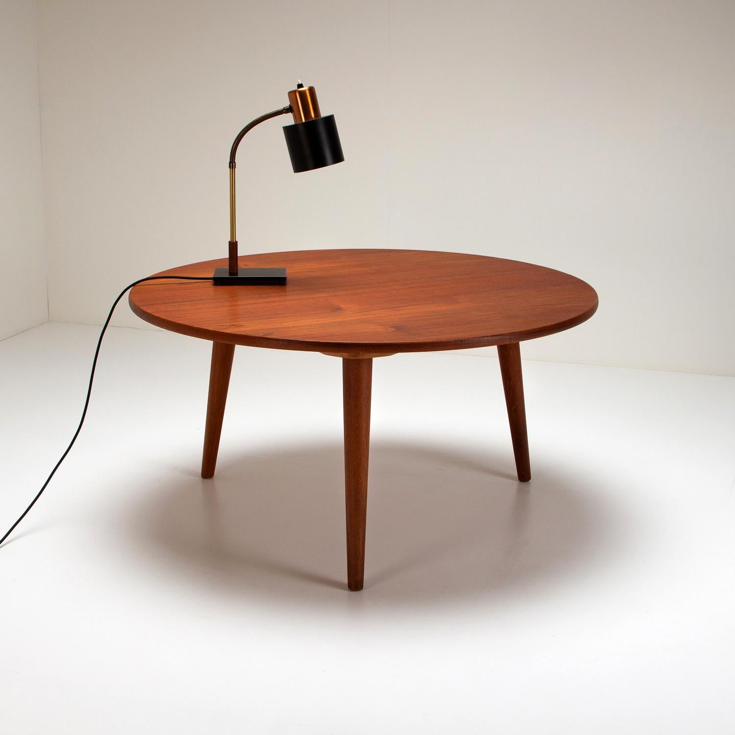 A Model AT 8 three-leg, circular coffee table in teak designed by Hans Wegner and made by master cabinetmaker Andreas Tuck. Denmark, 1950s.

 