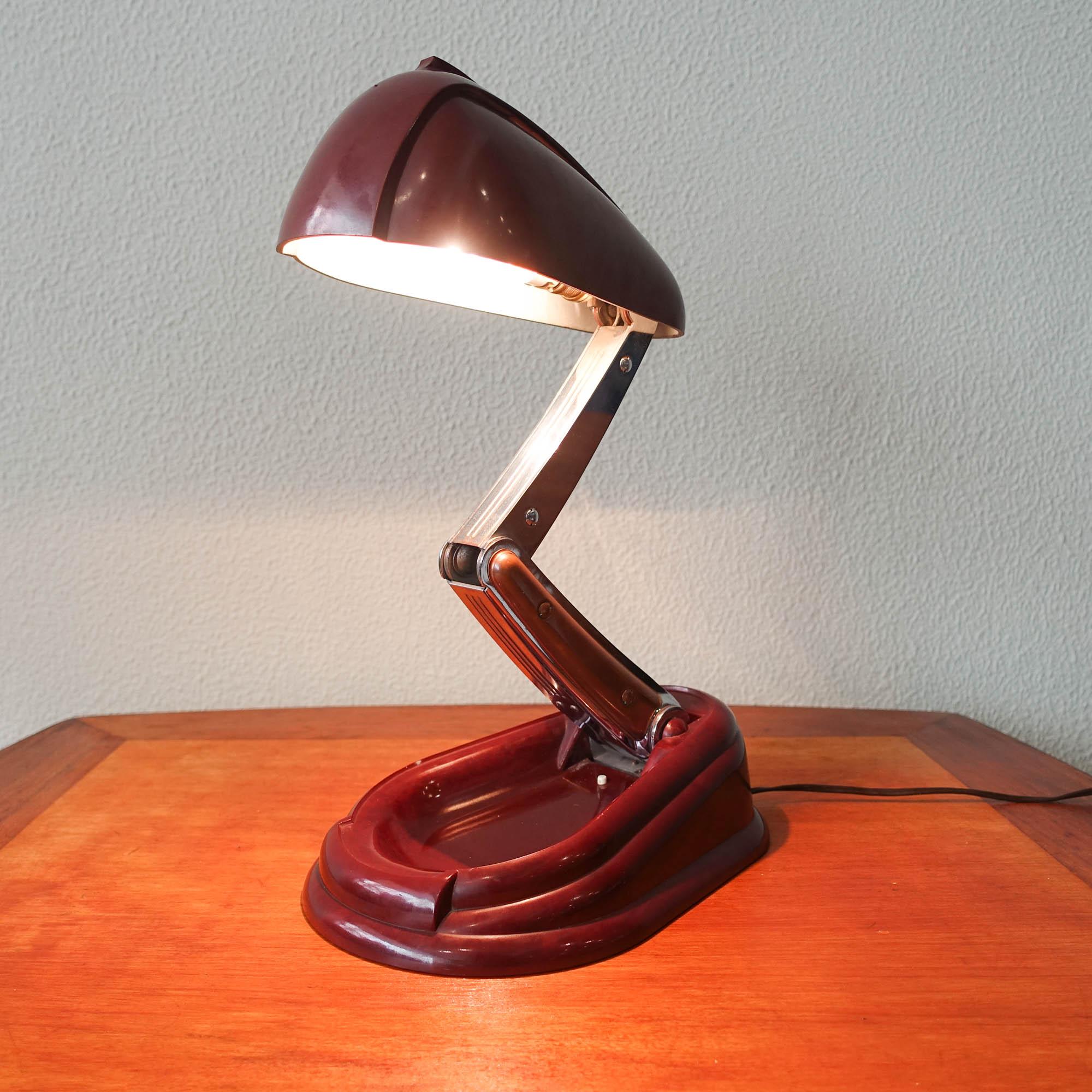 Step back in time to the 1940s with this exquisite table lamp designed and produced by JUMO Brevete in France. Founded by Yves Jujeau and Pierre and André Mounique, the JUMO company was renowned for its innovative designs and high-quality