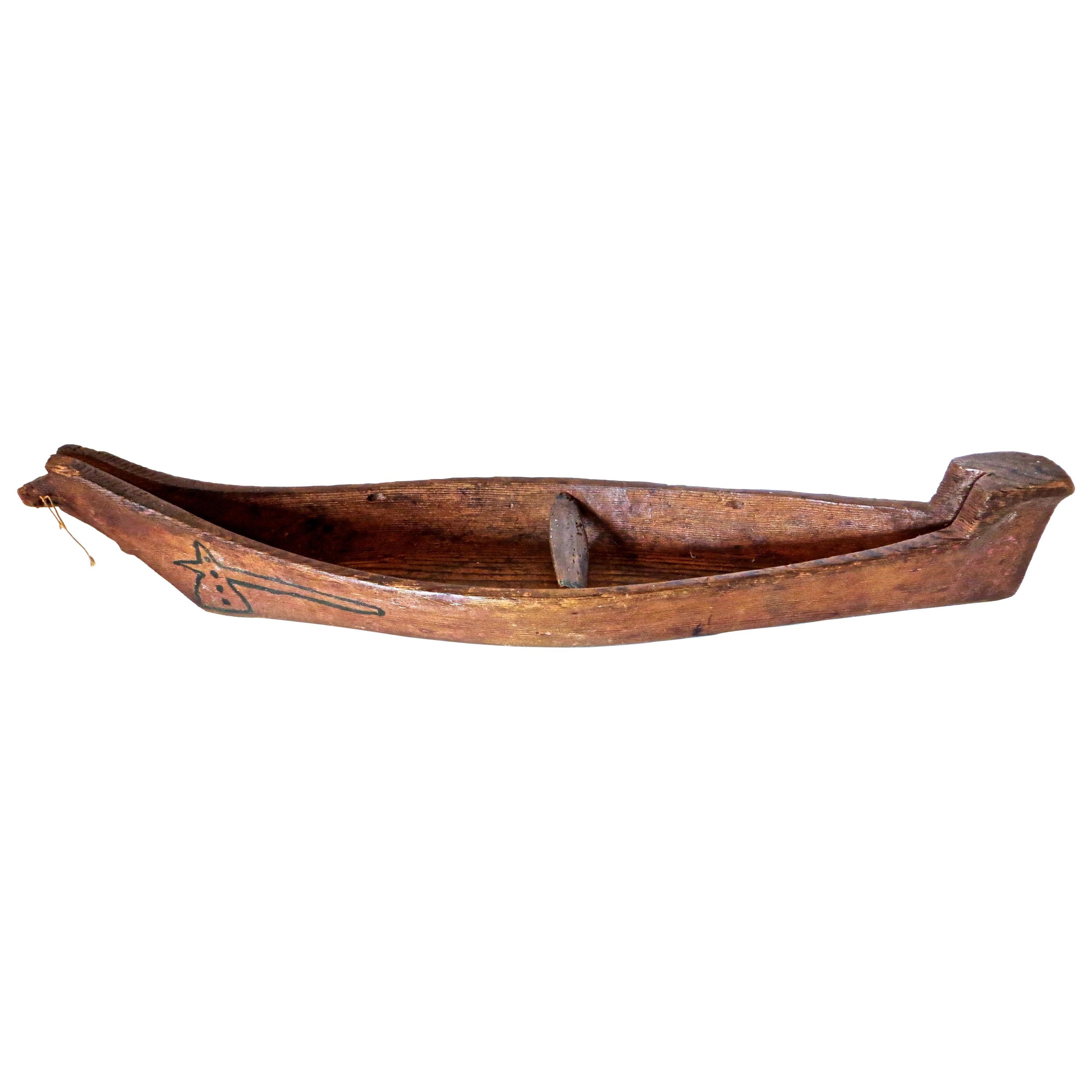 Displayed on a custom made metal stand designed especially for this boat, this is a typical model dugout canoe carved by the Nootka or Makah Indian tribe of the Pacific Northwest Coastal region of Vancouver Island or the lower mainland of British