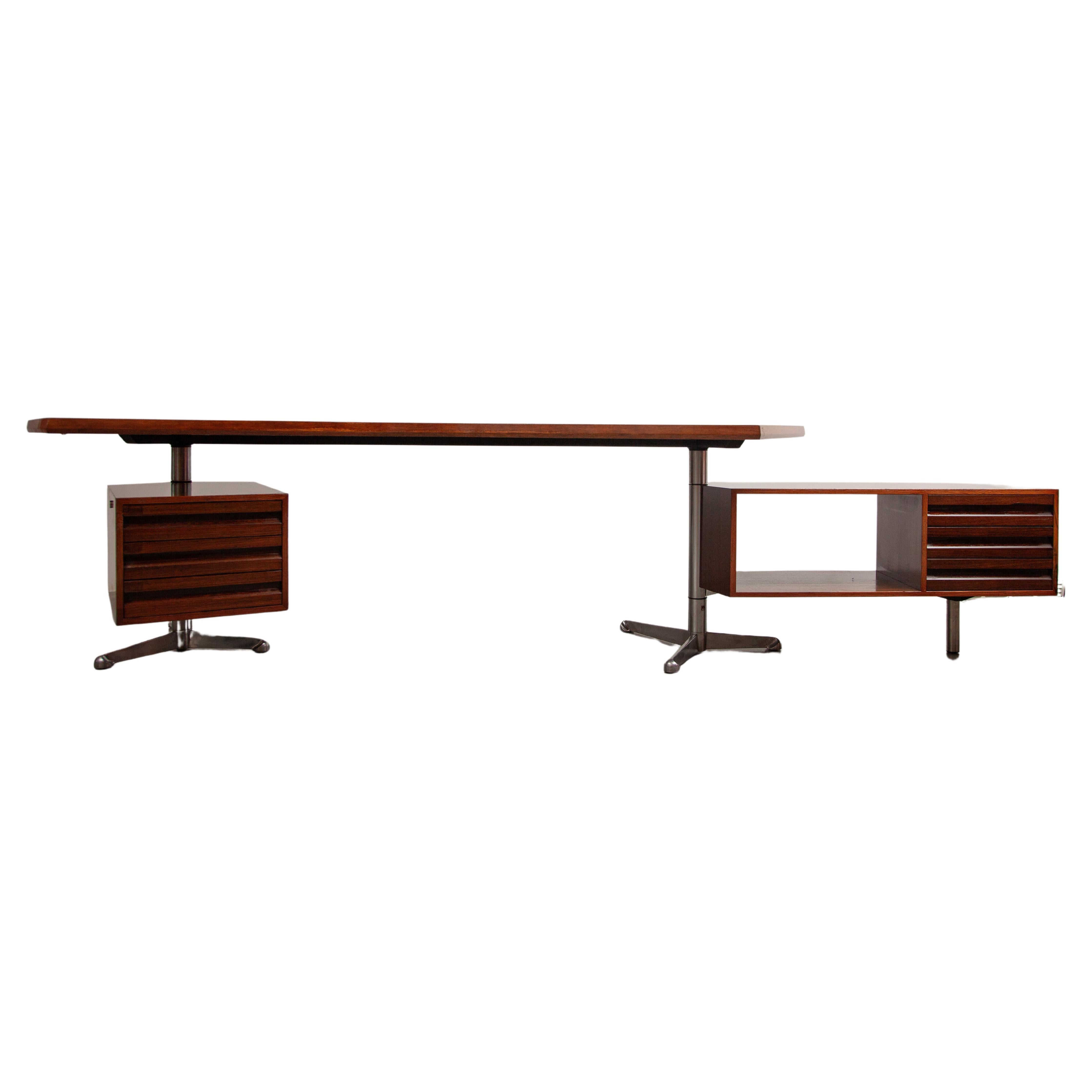 Model T96 office desk designed by Osvaldo Borsani and manufactured by Tecno, Italy 1956. The desk top shows a beautiful grain and deep warm colour with a leather inlay. 
The desk has metal and aluminium legs and walnut veneer top and compartments