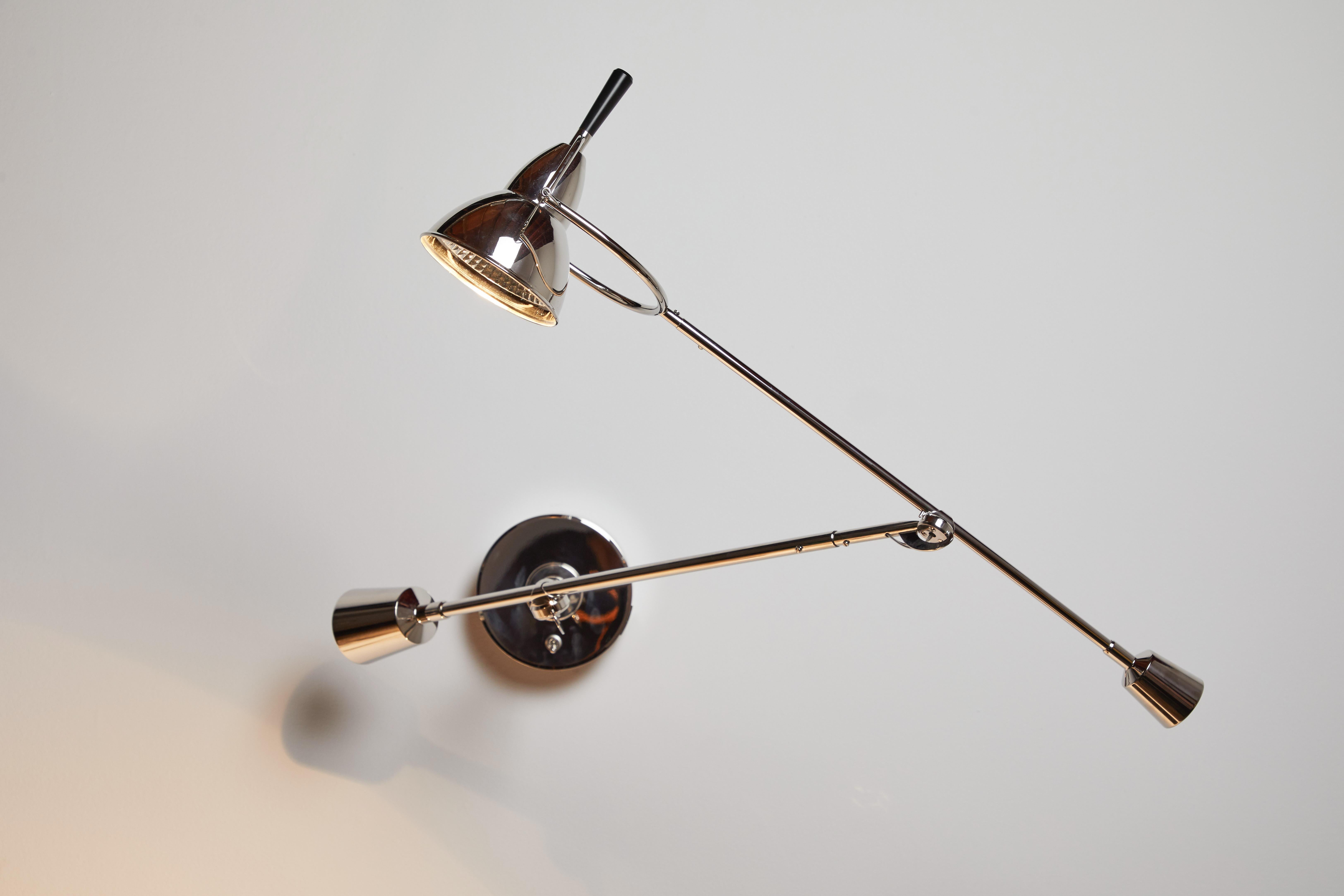 Model EB 27 wall light by Eduard-Wilfrid Buquet. Originally designed in 1927. Current production manufactured in Germany for Tecnolumen. Nickel plated metal. Wired for U.S junction boxes. Shade and arms adjust to various positions. Takes one GY
