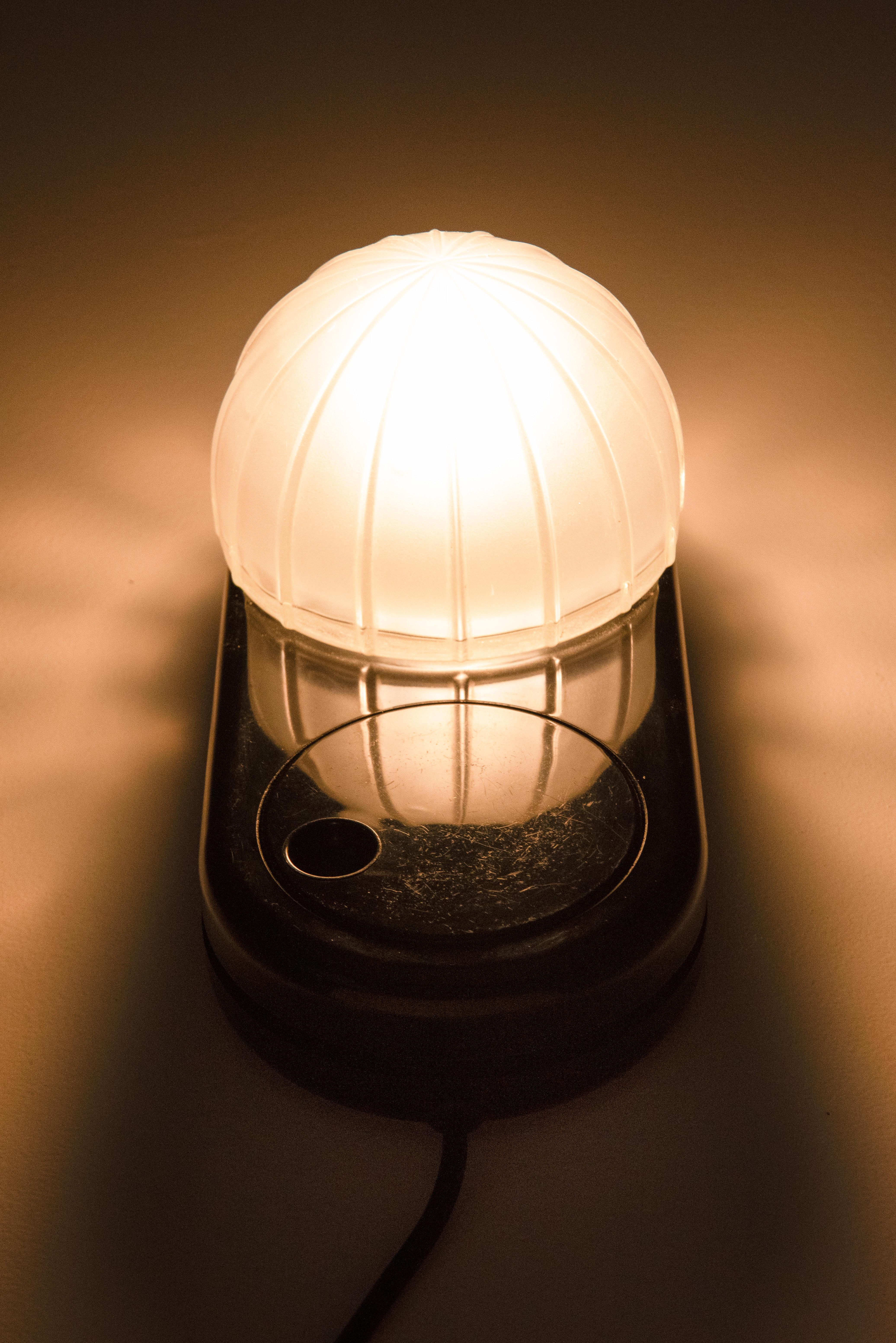 Model 'Farstar' table / desk lamp designed in the 1970's by Adalberto Dal Lago for Francesconi, Italy.
Glass shade on black plastic base with large round light-dimmer.
The lamp can be used as a table lamp and sconce as well. The condition is very