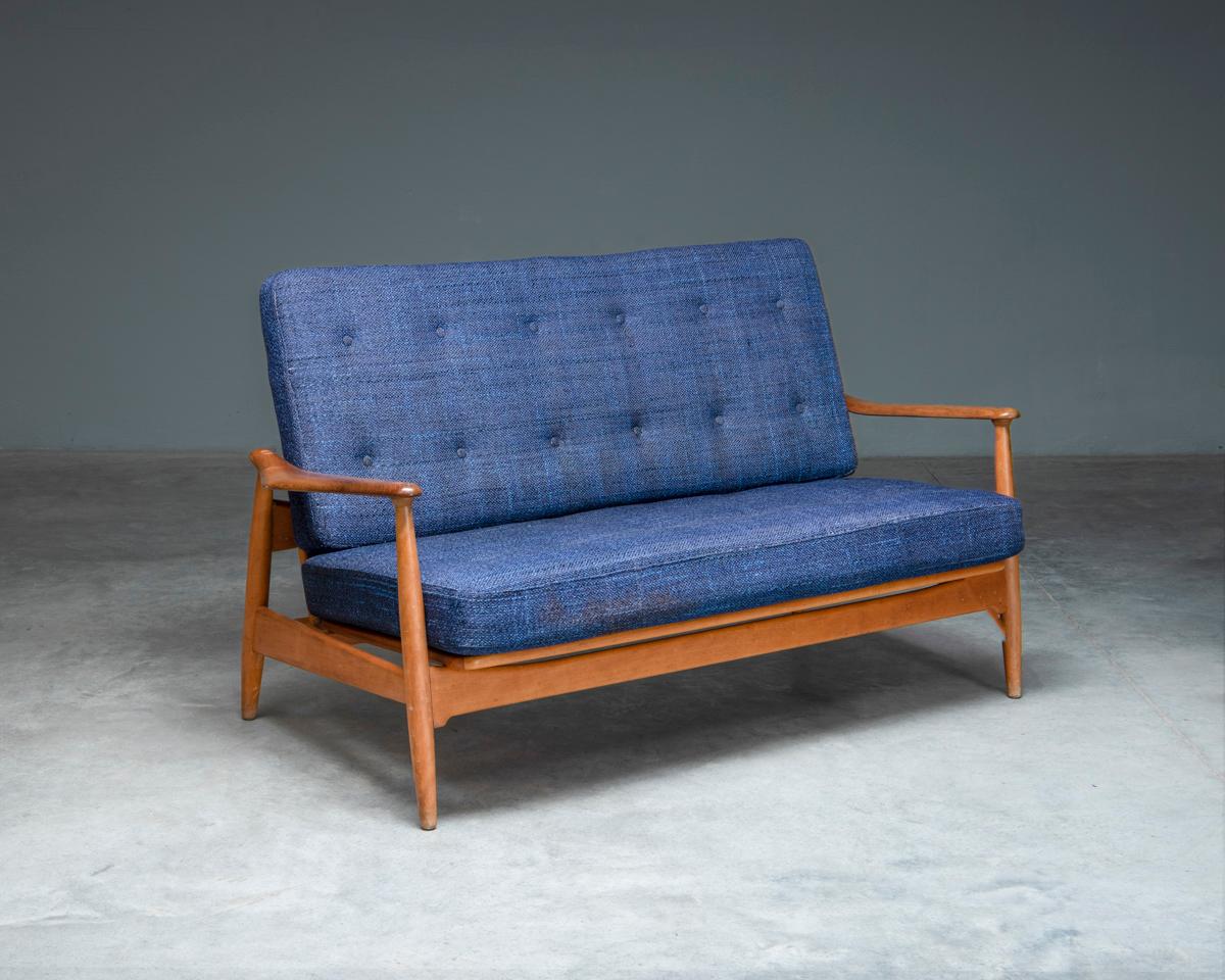 A Model FD161 2-seater sofa, designed in the 1950's by Arne Vodder for France & Daverkosen, Denmark. It consists of a frame in beech with teak armrests and its original blue cushions. 
The seating area is adjustable in two different positions
For