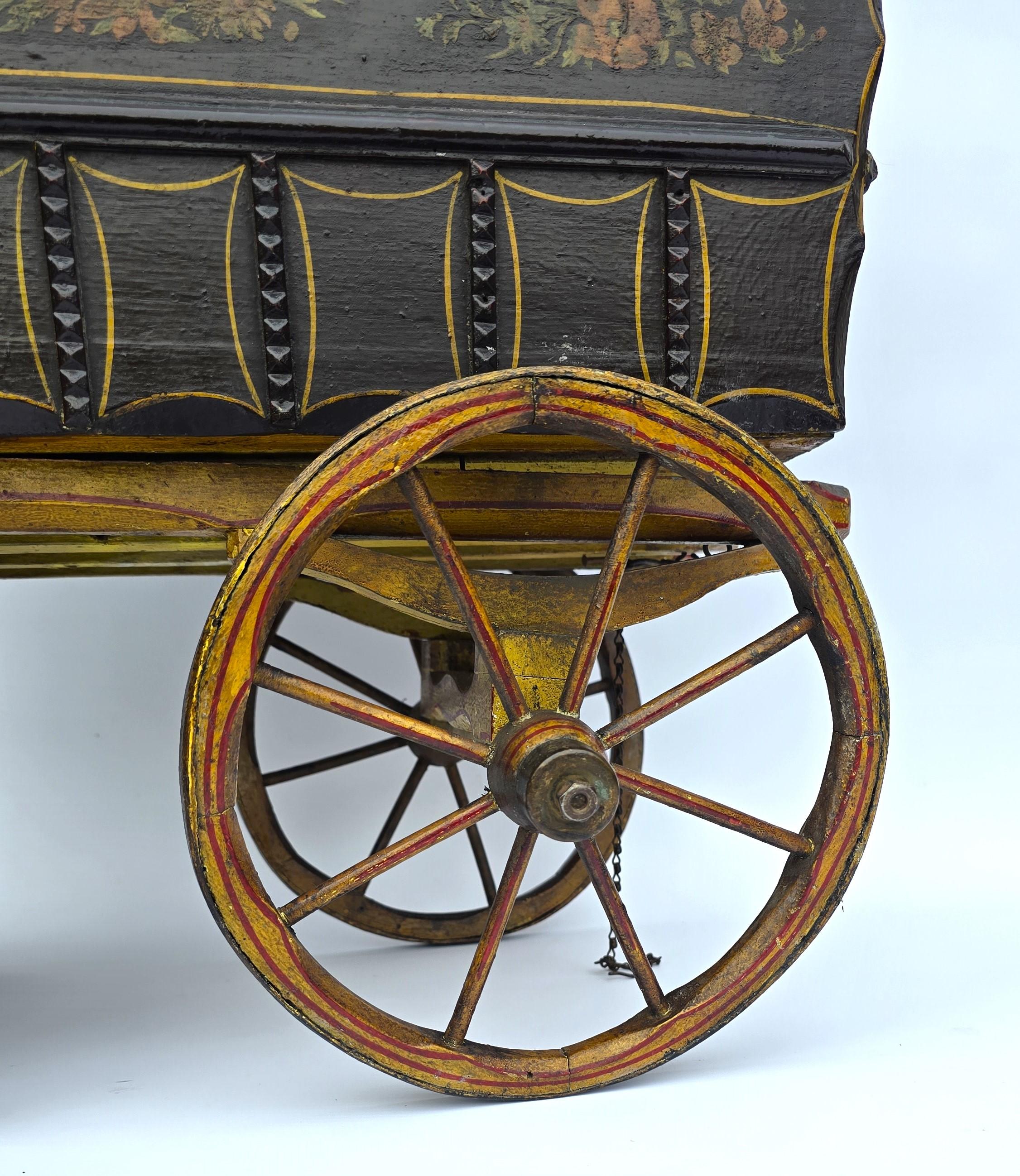Questo superbo e rarissimo modello di arte popolare in scala di una roulotte di zingari o viaggiatori ha più di cento anni. È stato realizzato a mano e finemente dipinto. Ha finestre in vetro, una mezza porta incernierata, ruote a raggi con pesanti