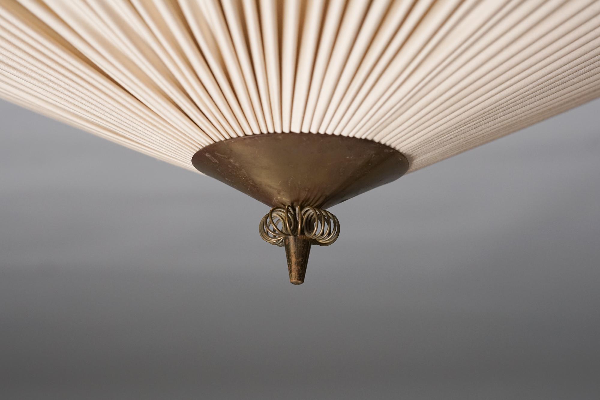 Model K5-26 Flush Mount, designed by Paavo Tynell, manufactured by Idman Oy, 1950s. Fabric shade reupholstered with fire-safe fabric. Brass details. Marked. Great vintage condition, minor patina consistent with age and use. 

Paavo Tynell