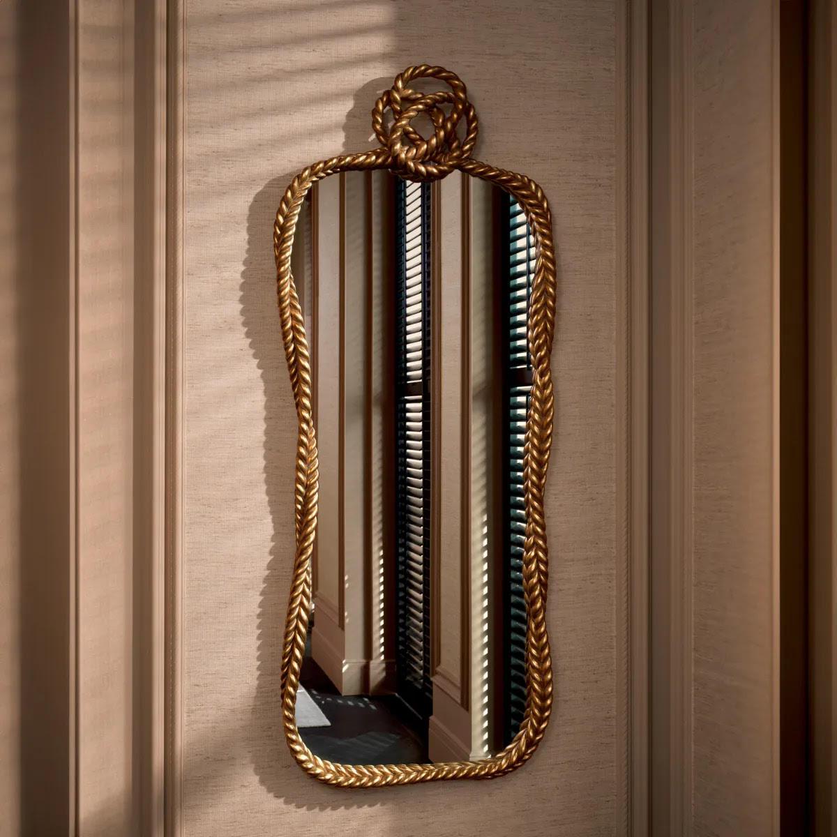 Scopri questo esclusivo specchio in legno con finitura oro invecchiato.
Questo specchio presenta un design che evoca il fascino di una corda attorcigliata con un nodo, aggiungendo un tocco di eleganza artistica al tuo spazio. Lo specchio combina