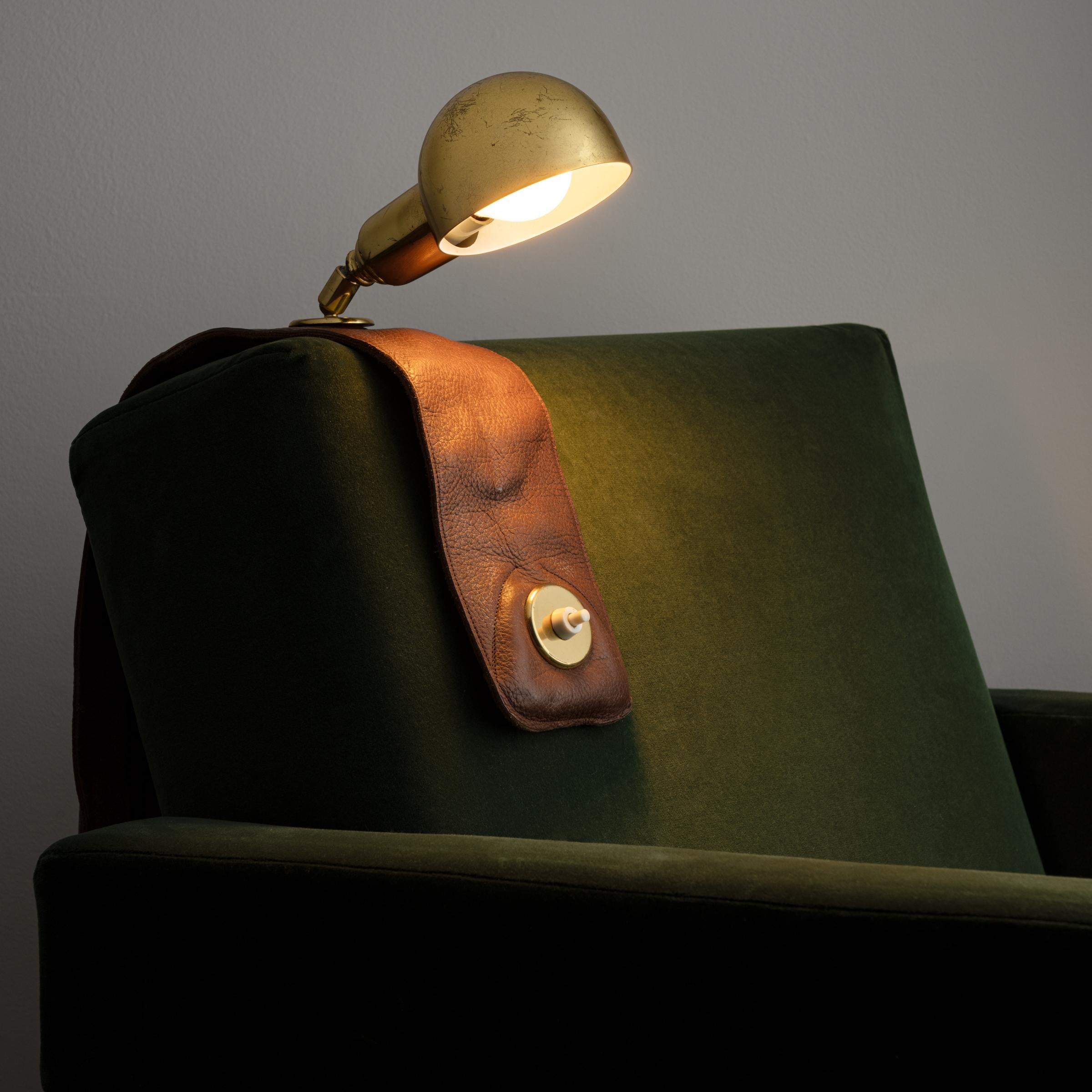 Model Lp01 armchair lamp by Luigi Caccia Dominioni for Azucena. Designed and manufactured in Italy, circa 1970s. Leather and brass. Brass shade adjust to various positions. We recommend one E27 40w maximum bulb. Bulbs not included.