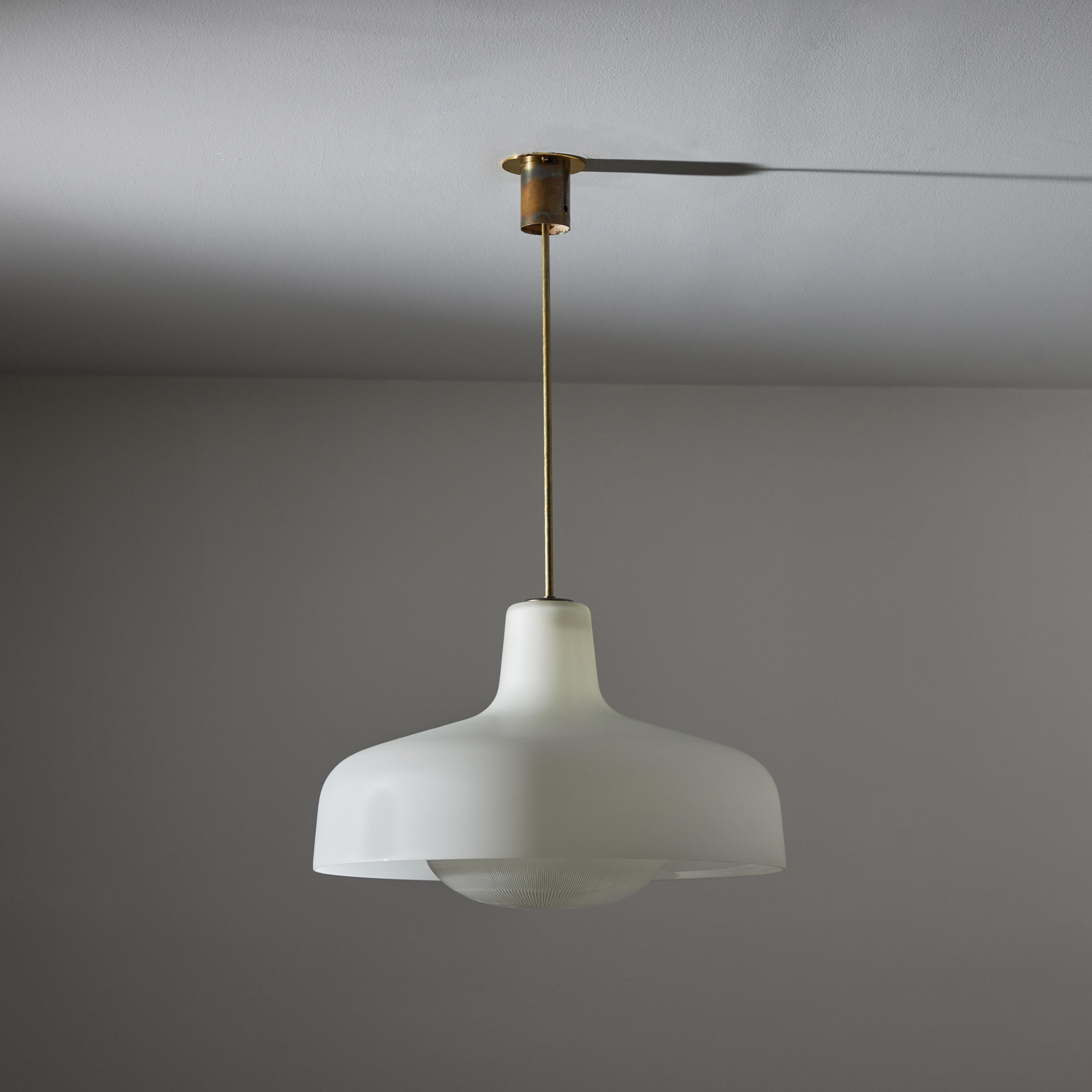 Model LS7 “Paolina” ceiling light by Ignazio Gardella for Azucena. Designed and manufactured in Italy, 1958. Exterior white glass, brass fixture stem and canopy, with reeded glass diffuser at the bottom. Original canopy, custom brass backplate. We
