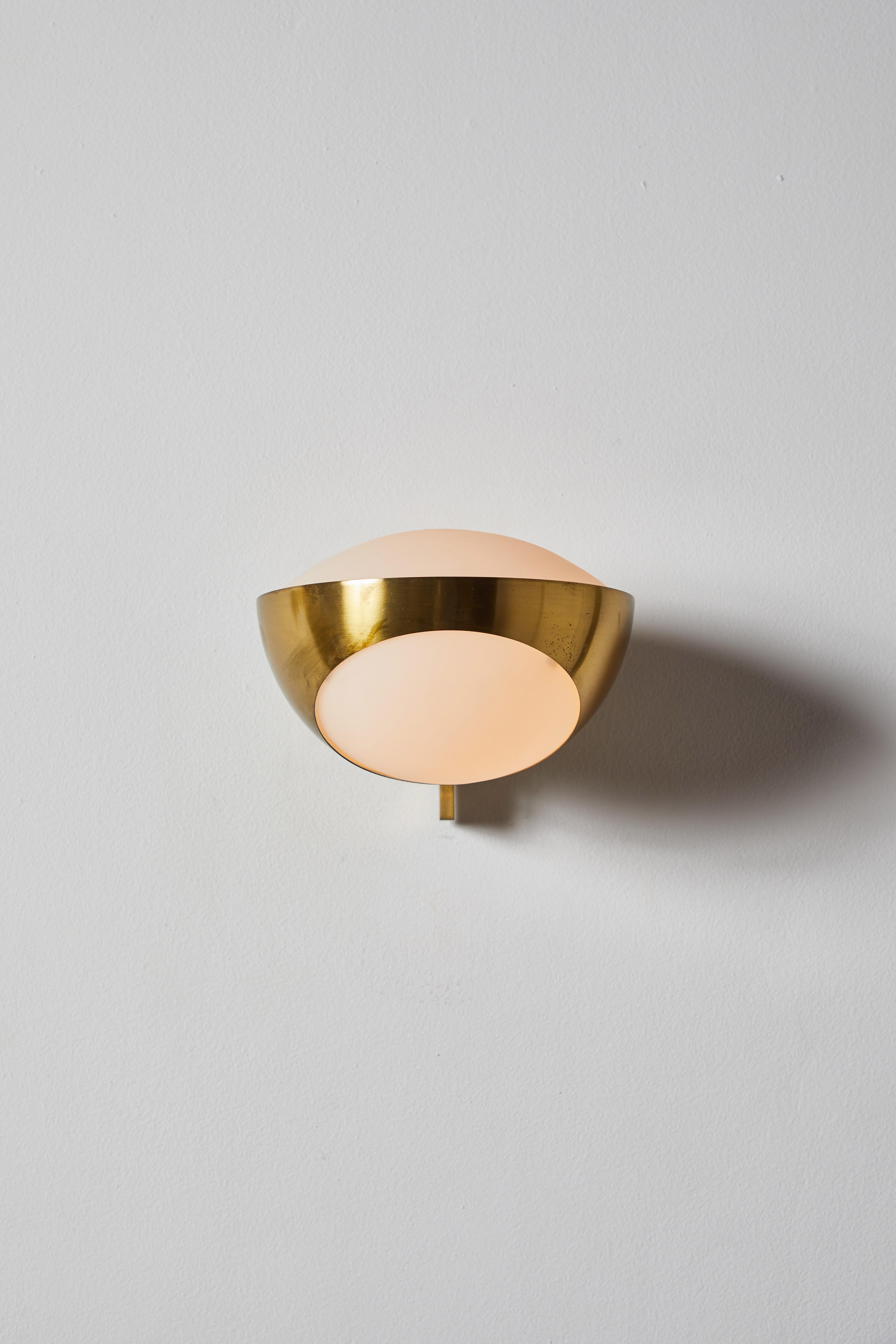 Single model no. 1963 sconce by Max Ingrand for Fontanta Arte. Designed and manufactured in Italy, 1960. Brushed satin glass diffuser, brass armature. Custom brass backplates. Light takes one E27 60w maximum bulb. Bulbs are provided as a one-time
