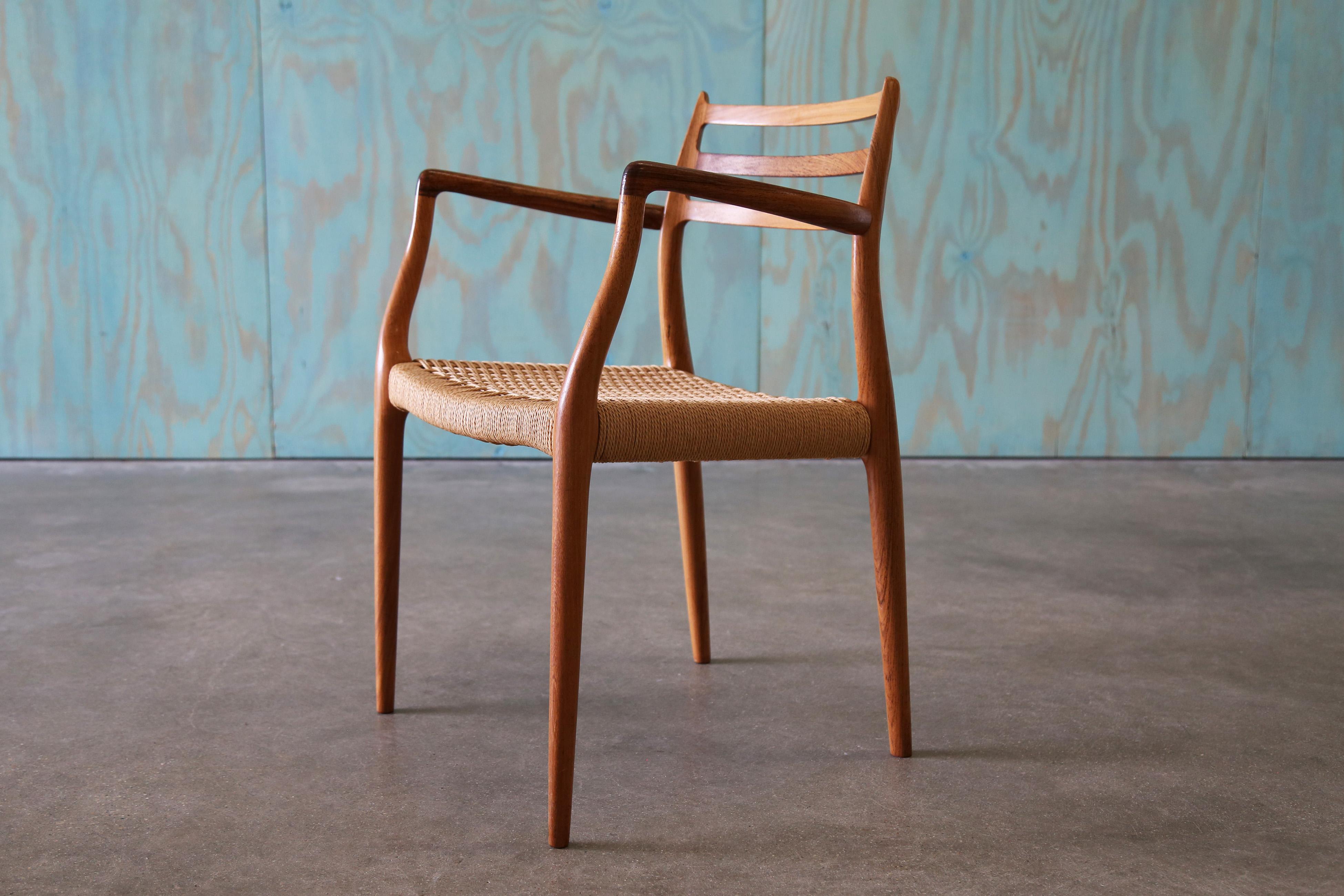 Iconic model no 62 armchair in rosewood and original papercord. A chair that shows great design and craftsmanship, the front legs are a continuation from the outward splay of the open arms, the solid rosewood beautifully worked. The back with three
