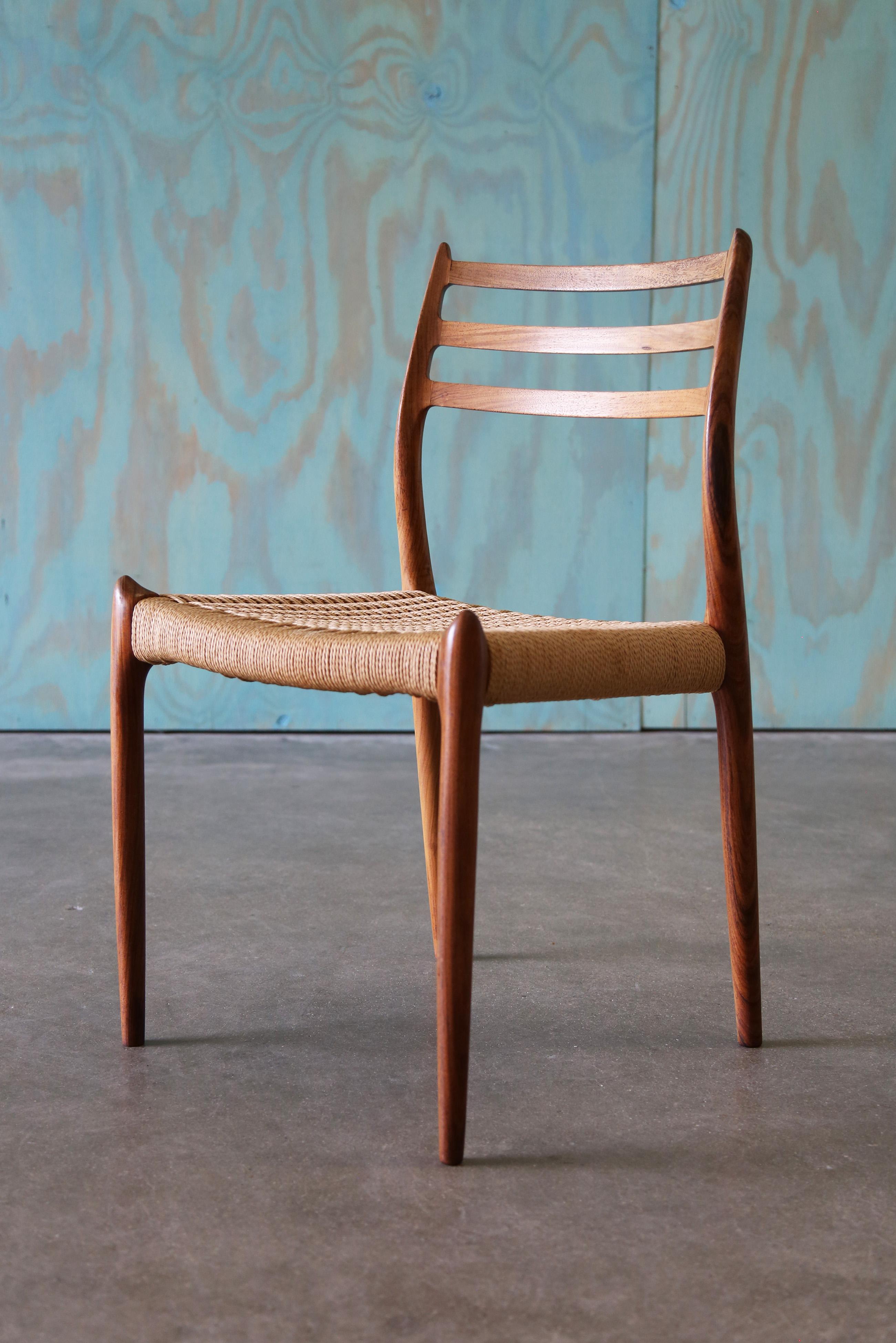 A model 78 rosewood and papercord chair designed by JL Moller. Rosewood is highly coveted as, it was banned for export import in the late 70s and early 80s. Coveted for its expressive grain the rosewood features with the curved lines of the chair