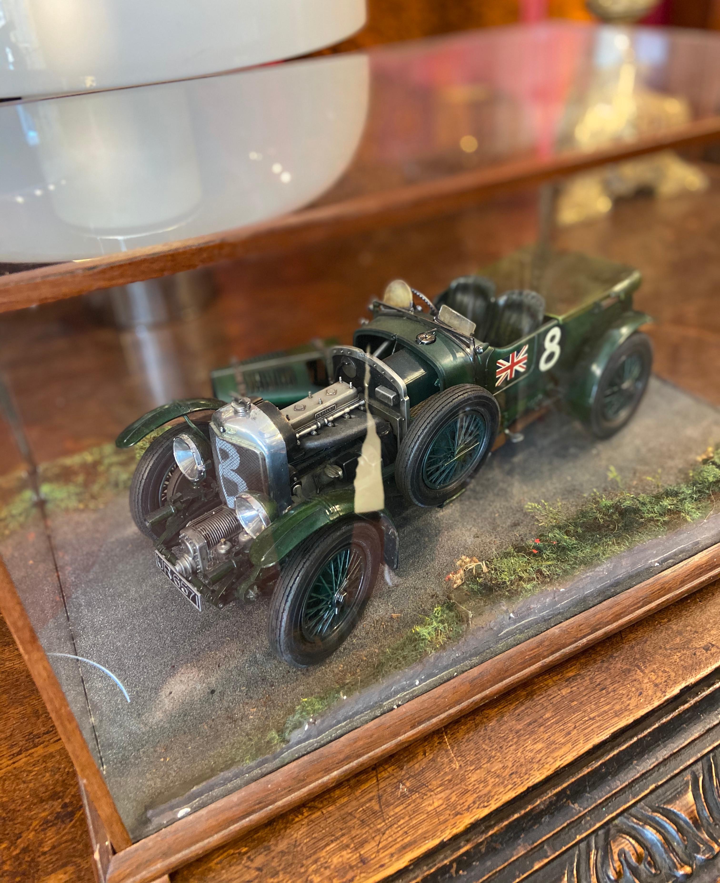 A beautiful kit built model of a 1930 'Blower' Bentley 4.5l racing car in 1:12 scale.

It is primarily of plastic construction and is attached to a wooden base with glazed removable cover.

This model was hand painted by one of the artists who