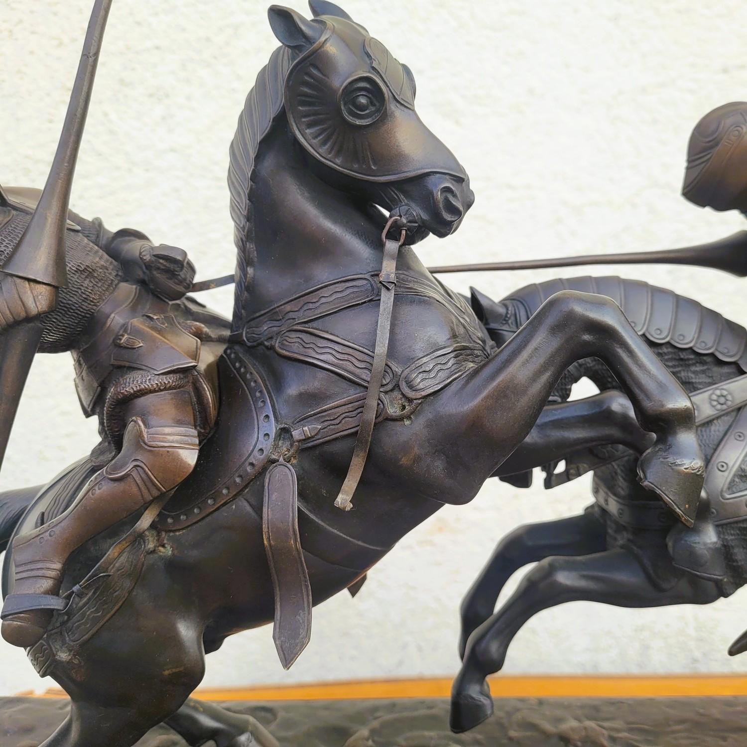 Large bronze representing the Death of the Duke of Clarence during a tournament: beautiful brown patina, the large quantity of details of precision and finesse make this sculpture lively and dynamic.  

The base in the Gothic style in carved wood,