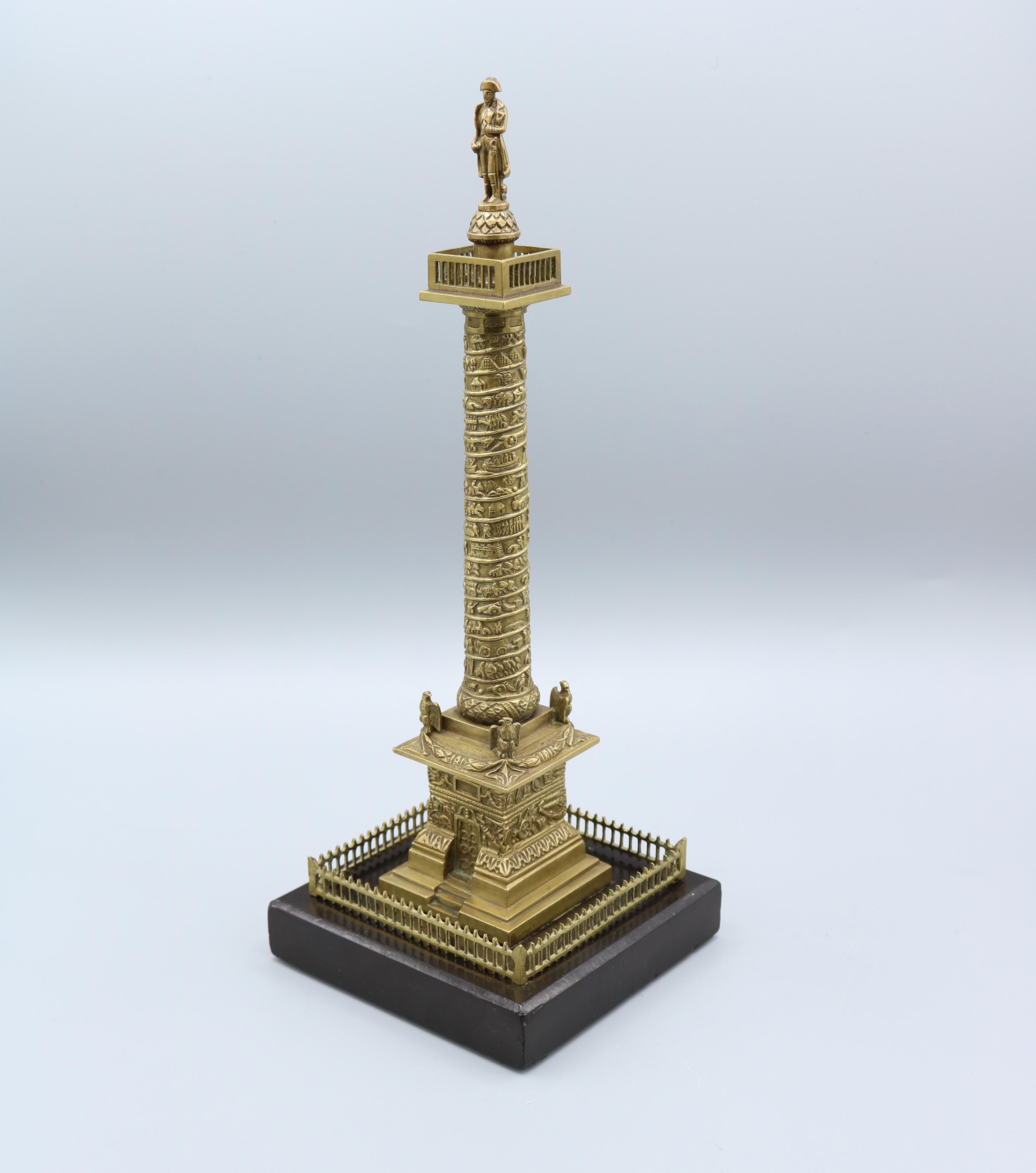 A well cast gilt-brass model of the Place Vendôme Column surmounted by Napoleon, supported on black marble plinth. The actual Vendôme Column was erected to celebrate the victory of Austerlitz; its veneer of 425 spiralling bas-relief bronze plates
