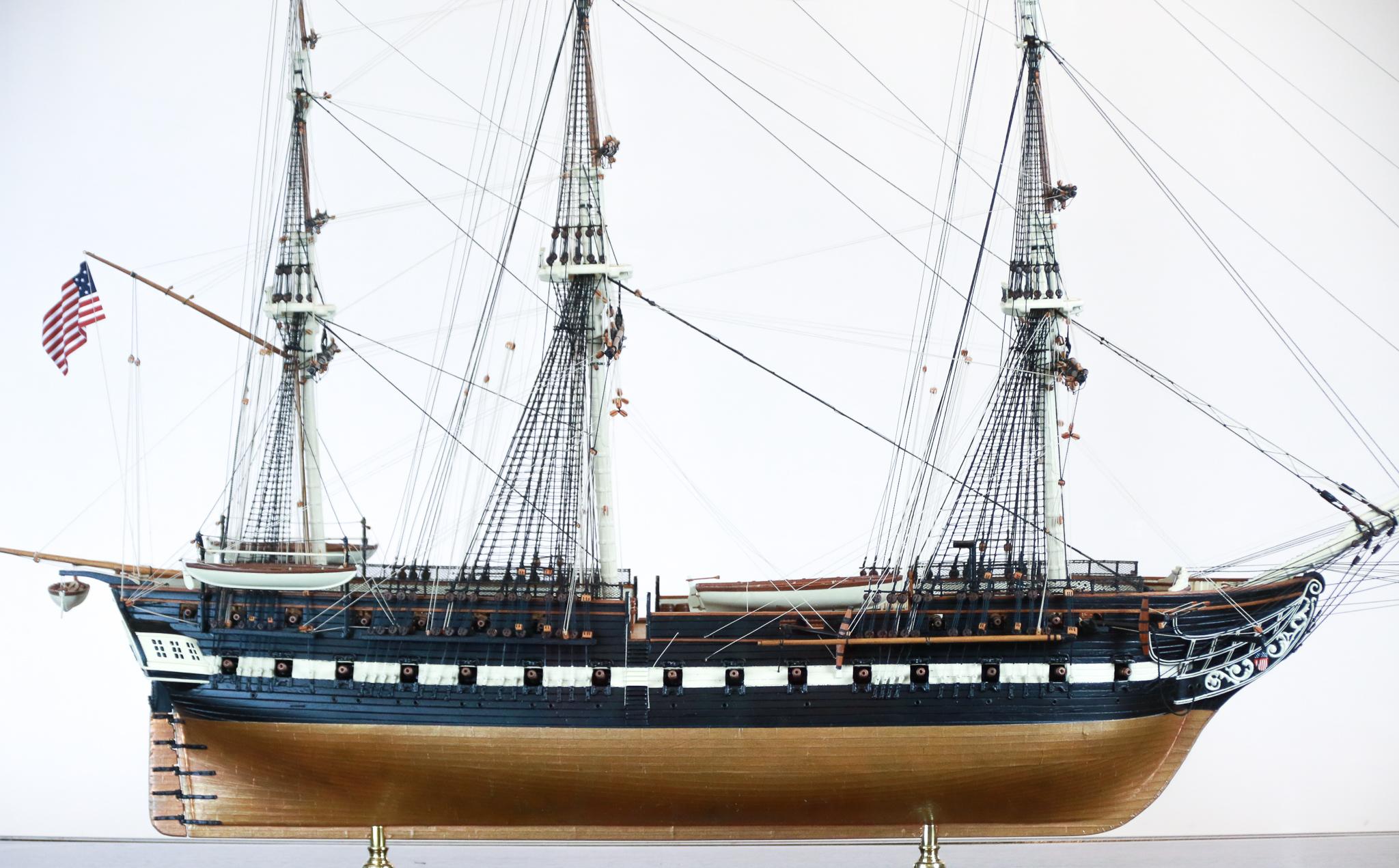 Model of the USS Constitution in a glass display case with custom table stand.