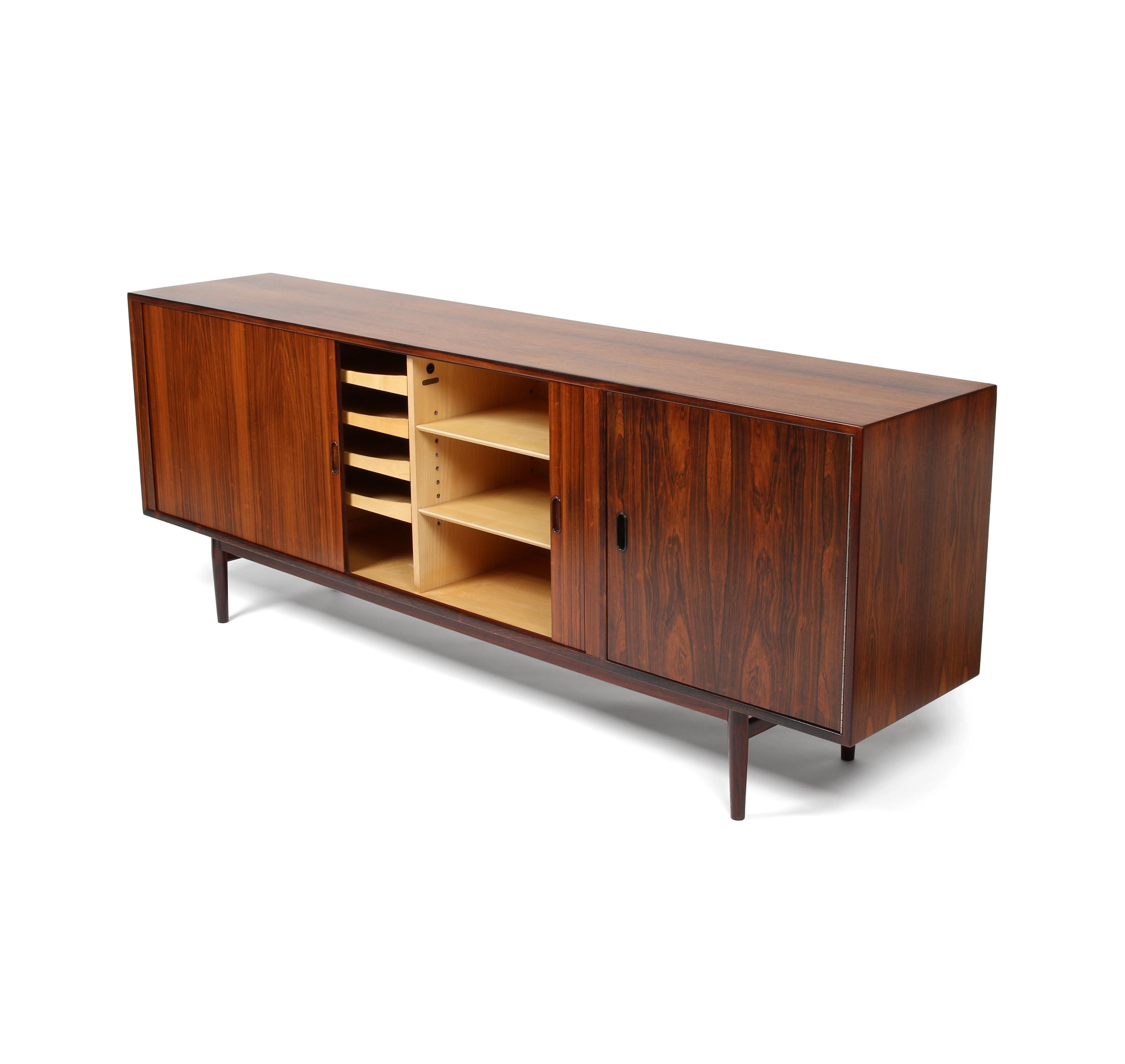 Here is a beautiful model OS-36 rosewood credenza by Arne Vodder for Sibast Furniture. Made in Denmark, circa 1960s. This is long and low, and features lots of storage and drawers behind long tambour doors, and a mirrored bar cabinet behind the