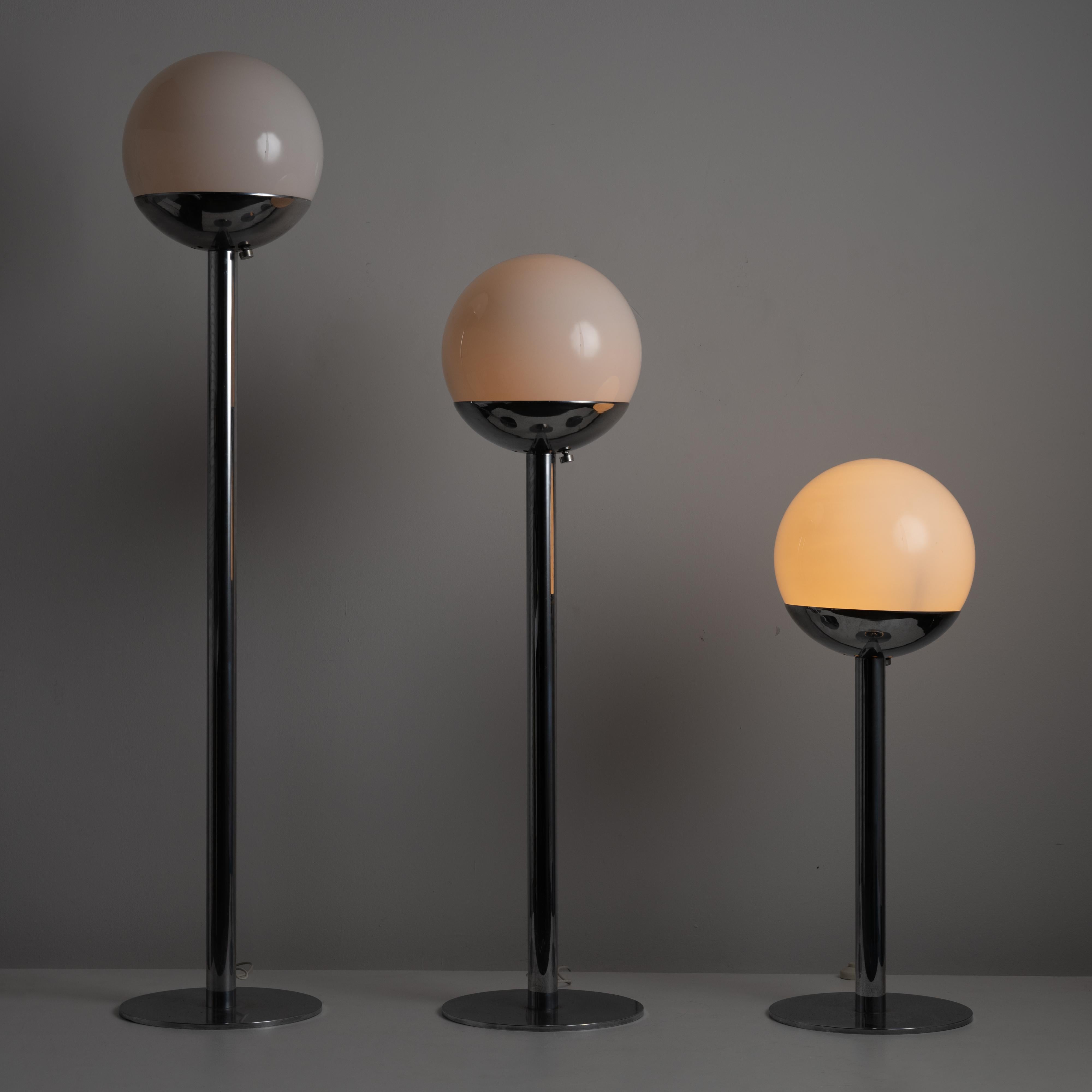 Model P428 floor lamps by Pia Guidetti Crippa for Luci Italia. Designed and manufactured in Italy, circa the 1970s. Classic, simple chrome post floor lamps in three different sizes. Heavy chrome bases hold very large opaline globes. The largest and