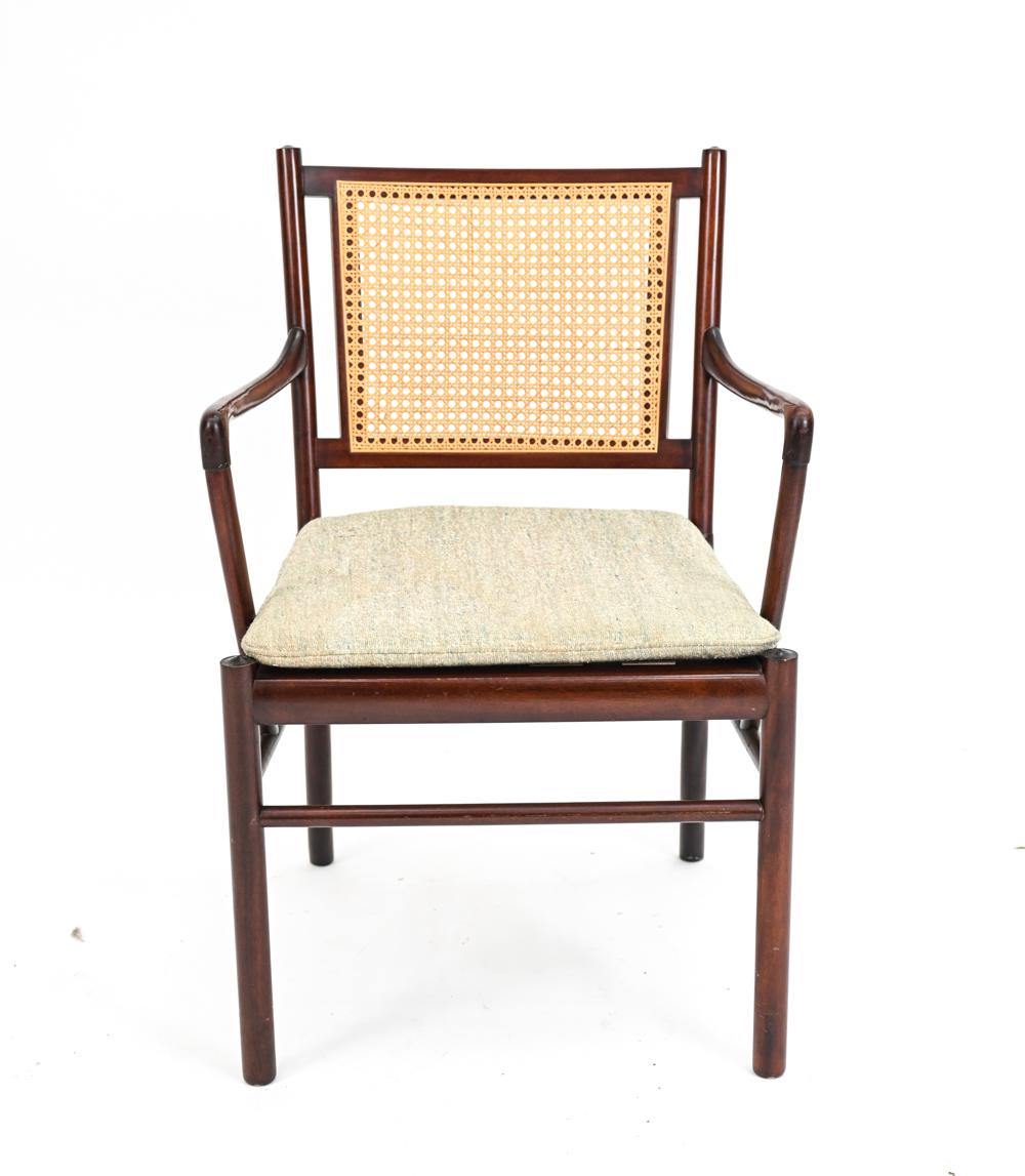 An iconic example of Scandinavian modern design, the model PJ-301 Colonial armchair was designed by Ole Wanscher for Poul Jeppesen, c. 1960's. This example is in fine mahogany with a caned back.

With manufacturer's label underneath.