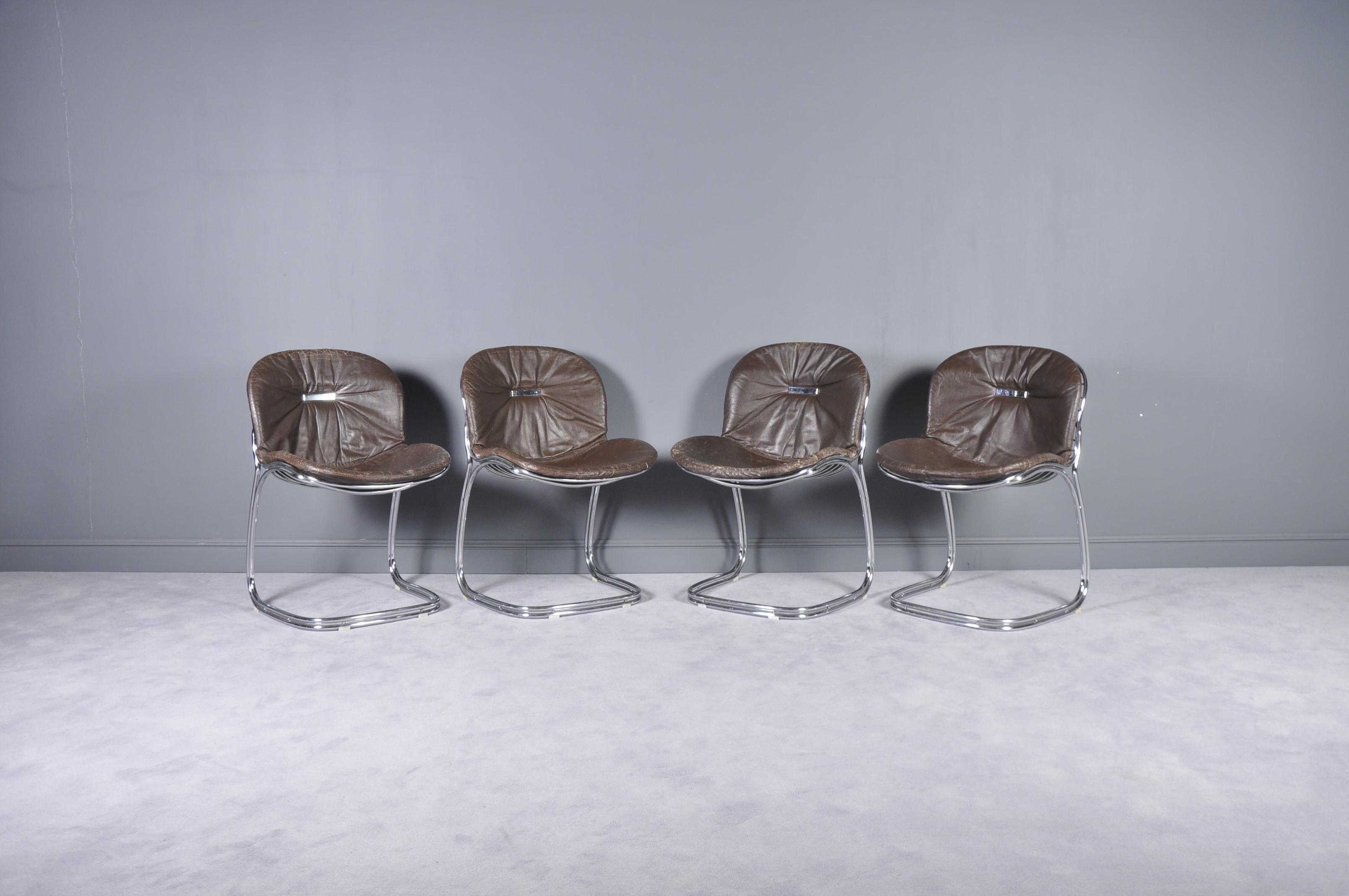 This set of four chairs, model Sabrina, was designed by Gastone Rinaldi for Rima in Padova, Italy during the 1970s. The cantilevered design features a chromed tubular steel frame and cushions covered with dark brown leatherette.