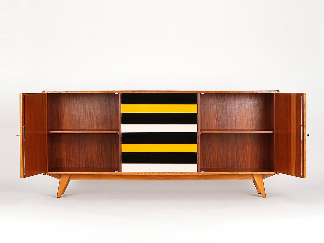 This model U-460 sideboard was designed by Jiri Jiroutek for Interier Praha in former Czechoslovakia. Produced in the 1960s. Completely restored. Excellent condition.
 It is an early model with wood drawers.