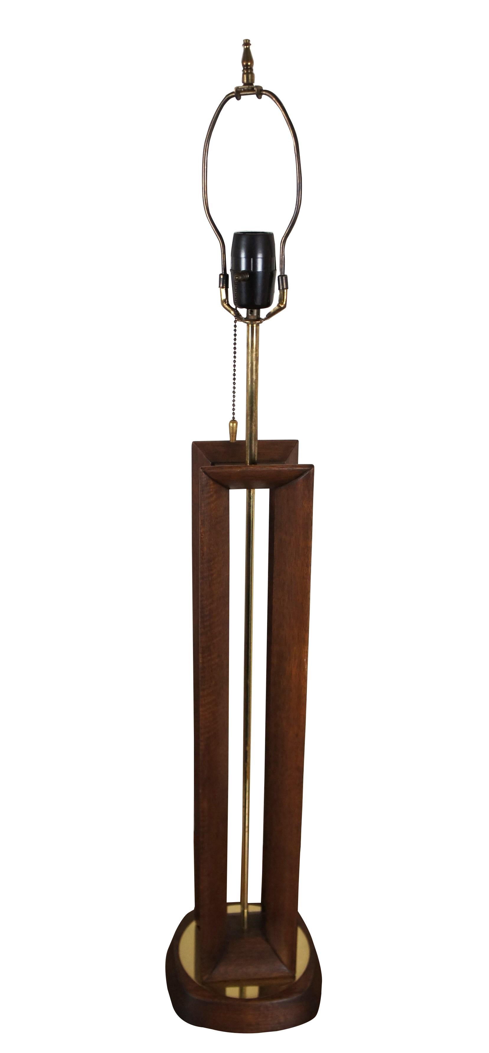 Mid 20th century Modeline Lamp Co modern walnut and brass table lamp featuring Scandinavian / Danish design with a cut out, beveled rectangular prism on a round base. Includes harp and finial.

Modeline was a lighting company based in California,