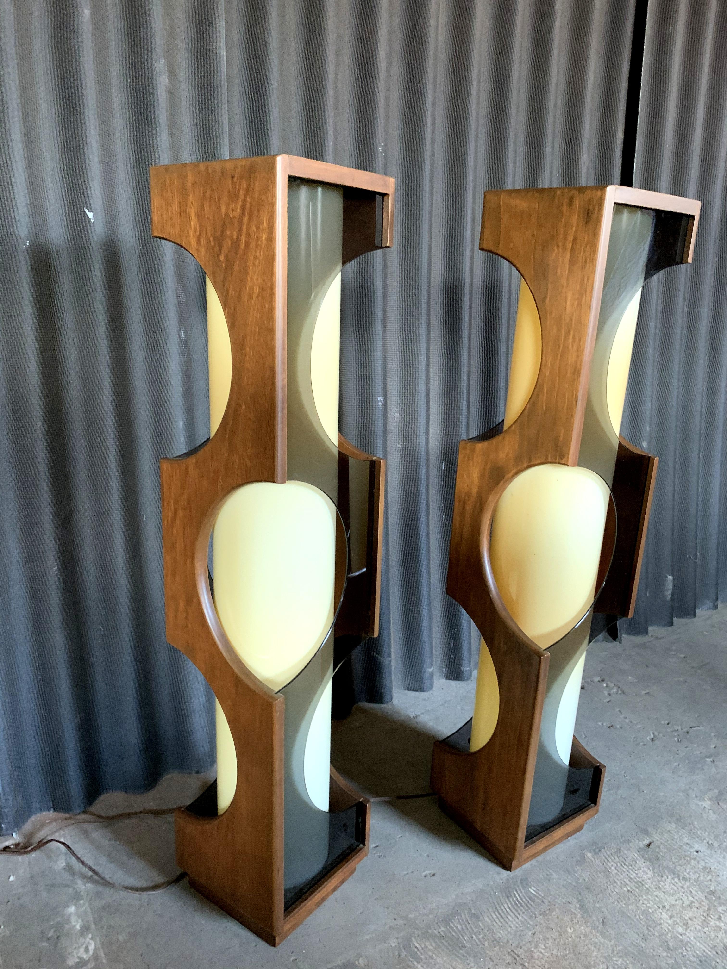 Incredible pair of large scale lamps by Modeline of California.
Walnut wood.
No breaks or chips anywhere.
Smoked Lucite.
Center is an opaque acrylic cylinder which houses two bulbs each.
Cylinders have yellowing as shown in the photos. Not