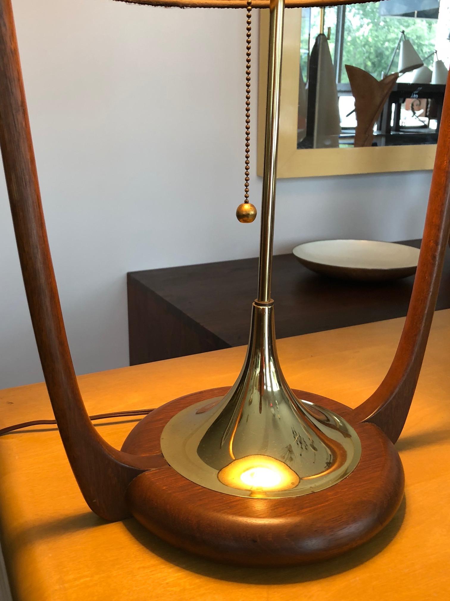 An unusual lamp by Modeline of California in hard to find excellent original condition. Walnut and brass details with original shade. The lap is tall at 43.5