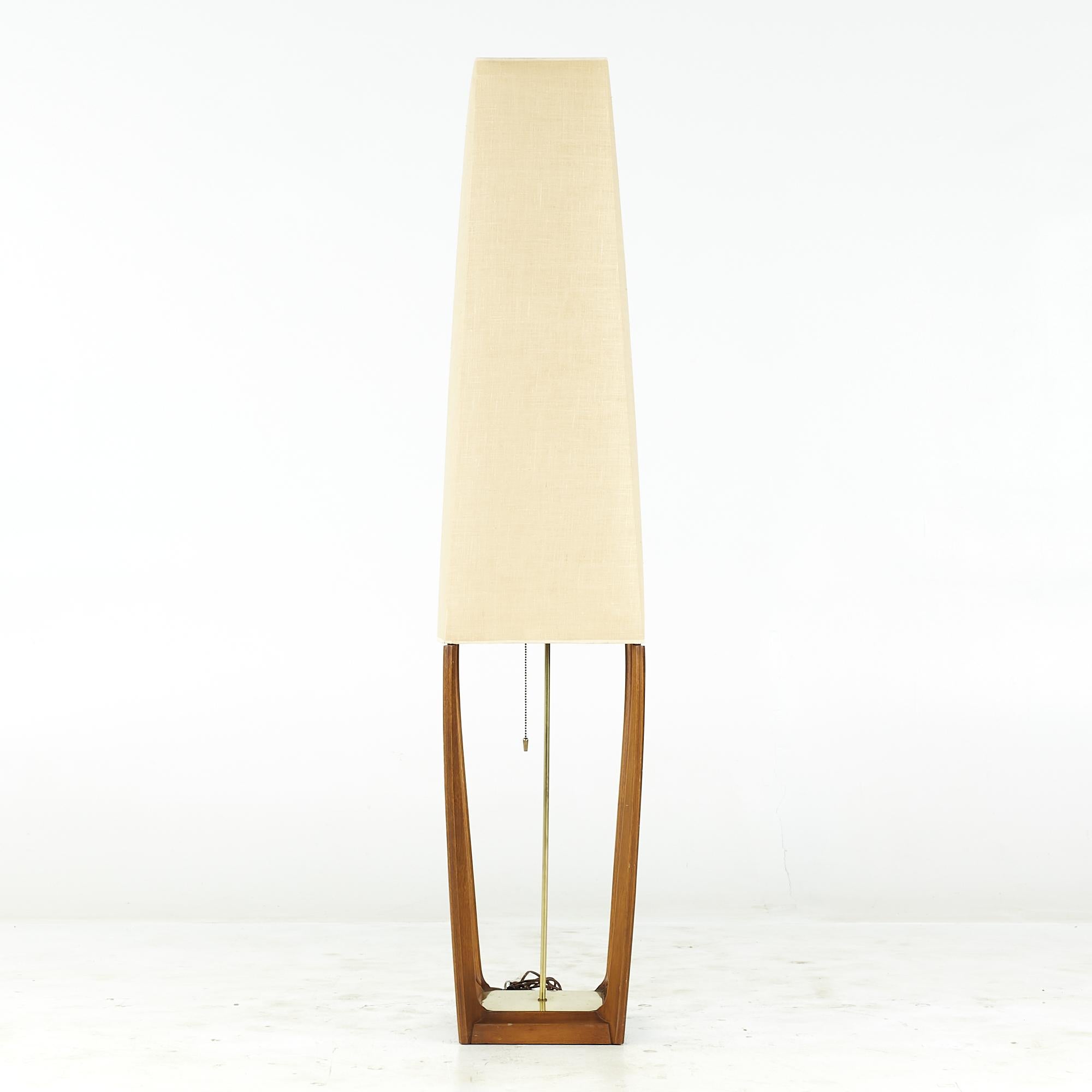 Modeline Style midcentury Walnut and Brass Floor Lamp

 This floor lamp measures: 12.25 wide x 12.25 deep x 60.5 inches high

We take our photos in a controlled lighting studio to show as much detail as possible. We do not photoshop out