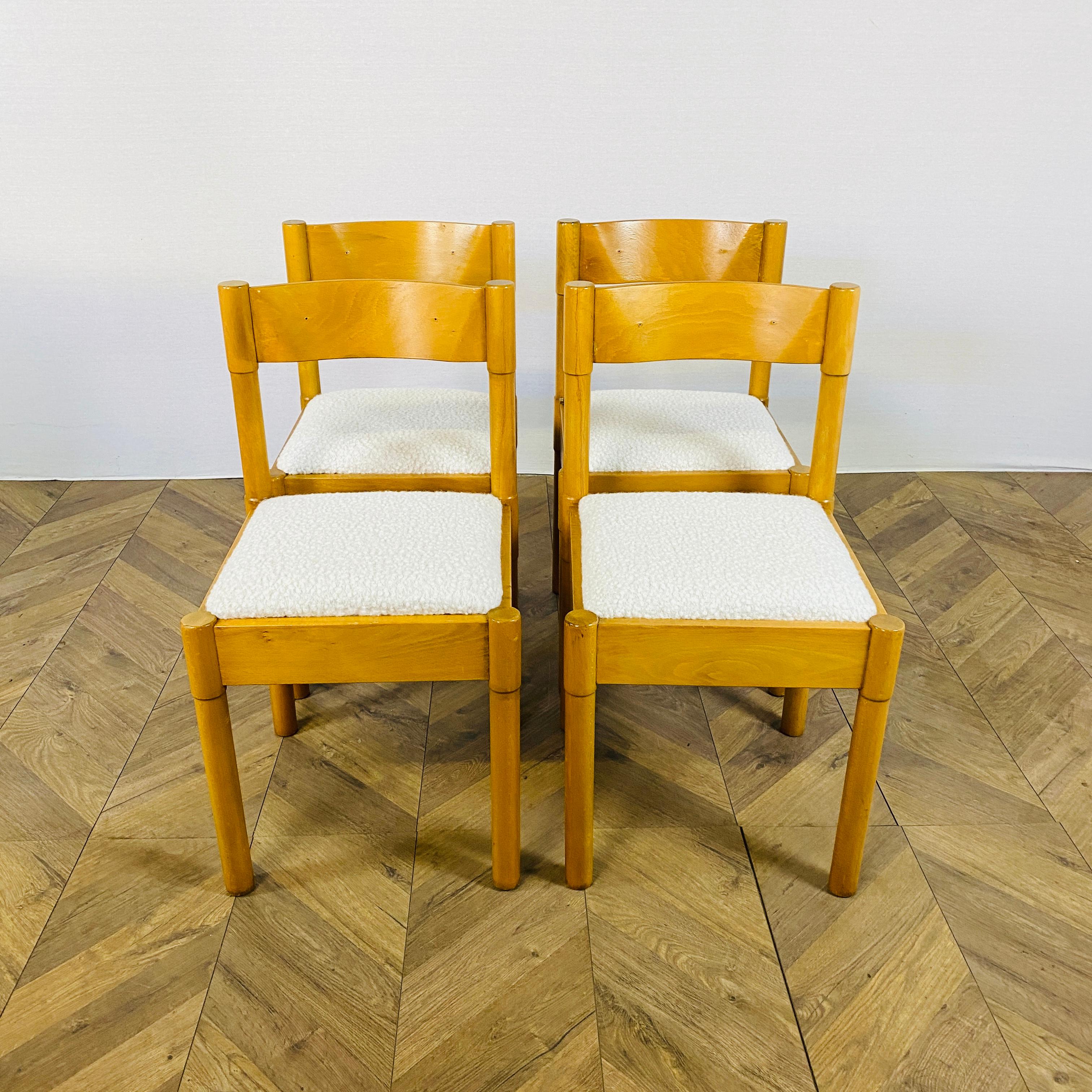 Set of 4 stylish mid century modello dining chairs by influential Italian Designer; Vico Magistretti for Habitat & Heals in the 1960’s.

Made from beech with white boucle upholstery, the chairs are in good condition but do have age related marks