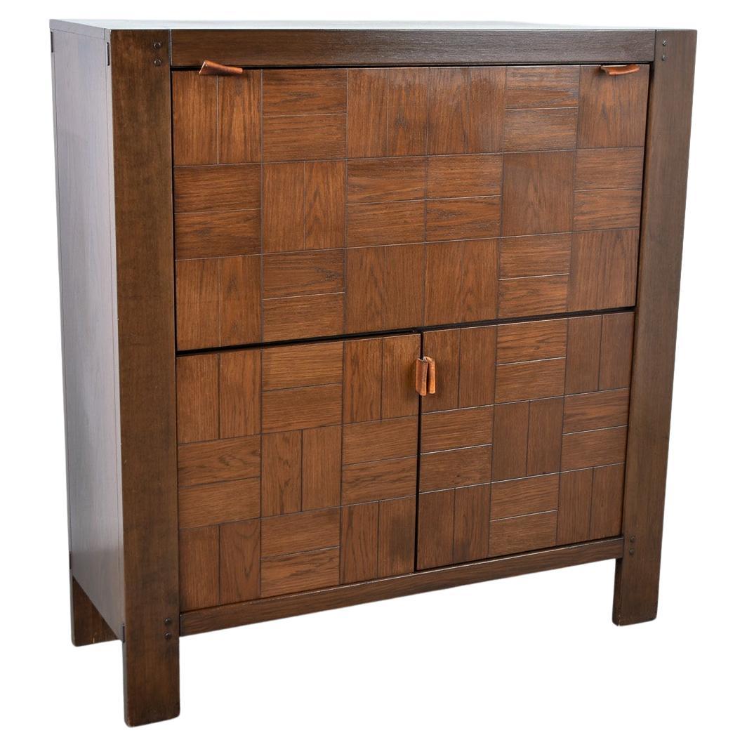 The 'Modena,' bar cabinet masterfully conceived by Frans Defour for the renowned establishment, Defour of Belgium, during the vibrant mid-1970s. Crafted with finesse, this cabinet amalgamates solid oak and veneer, yielding a harmonious blend of