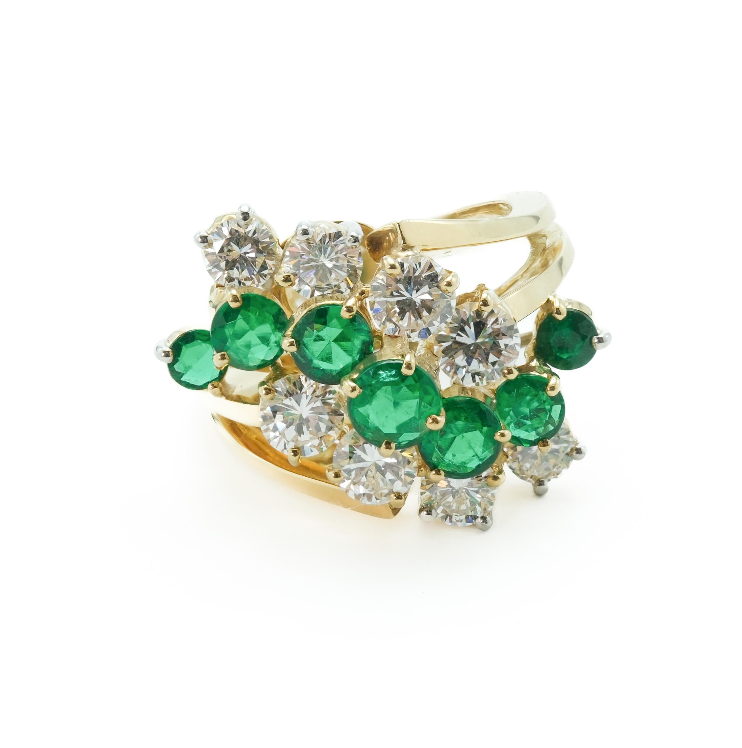 Modernist Kurt Wayne ring featuring 1.7 ctw emeralds and 1.9 ctw diamonds. This exquisite ring is designed in the style to make the emeralds the center of attention. The contrast of the clean white diamonds surrounding the forest green emeralds is