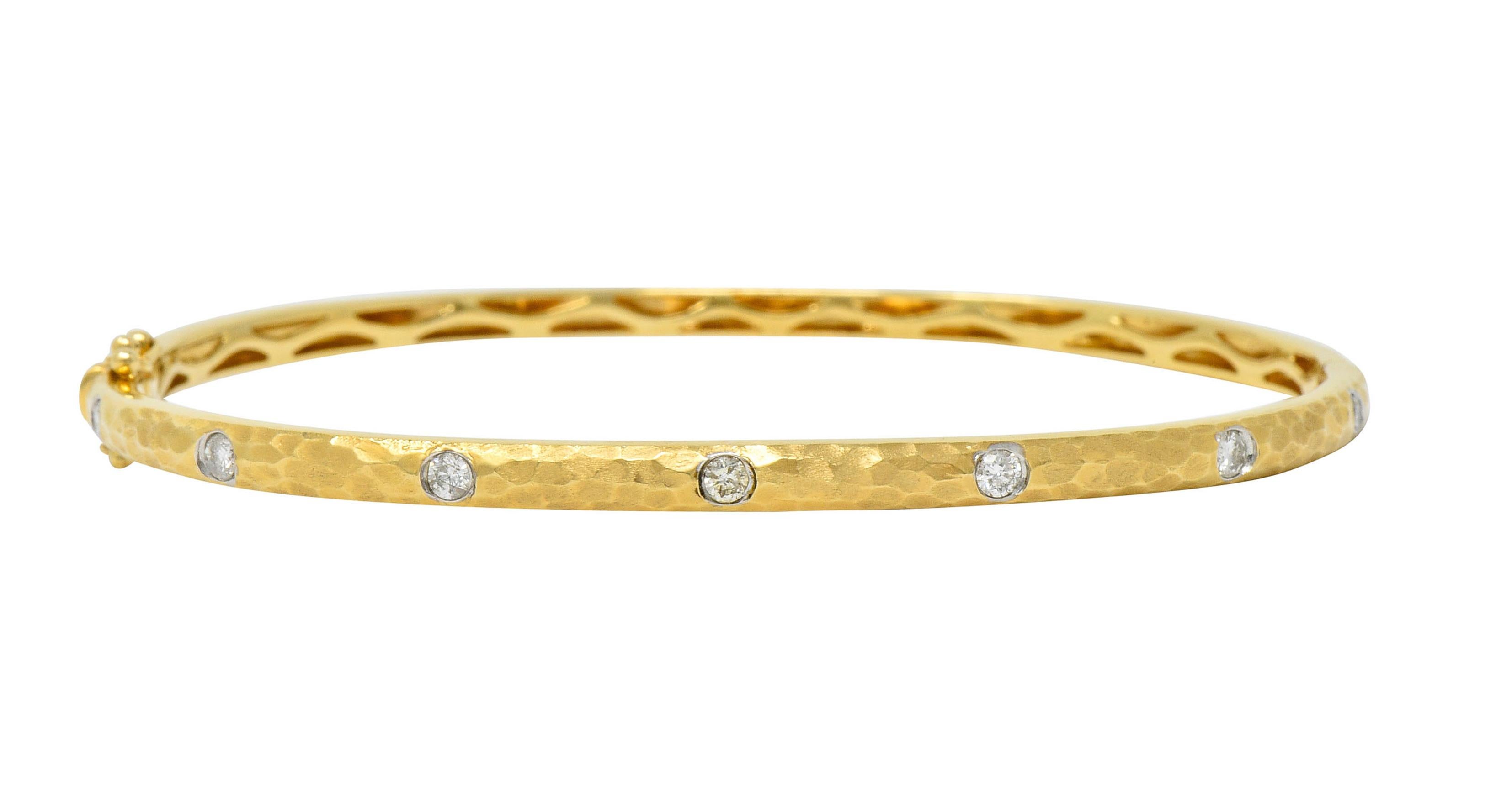 Hinged bangle bracelet with a strongly hammered and matte gold finish

Flush set to front, in white gold, by seven round brilliant cut diamonds

Weighing in total approximately 0.42 carat with H/I color and SI clarity

Completed by a concealed clasp