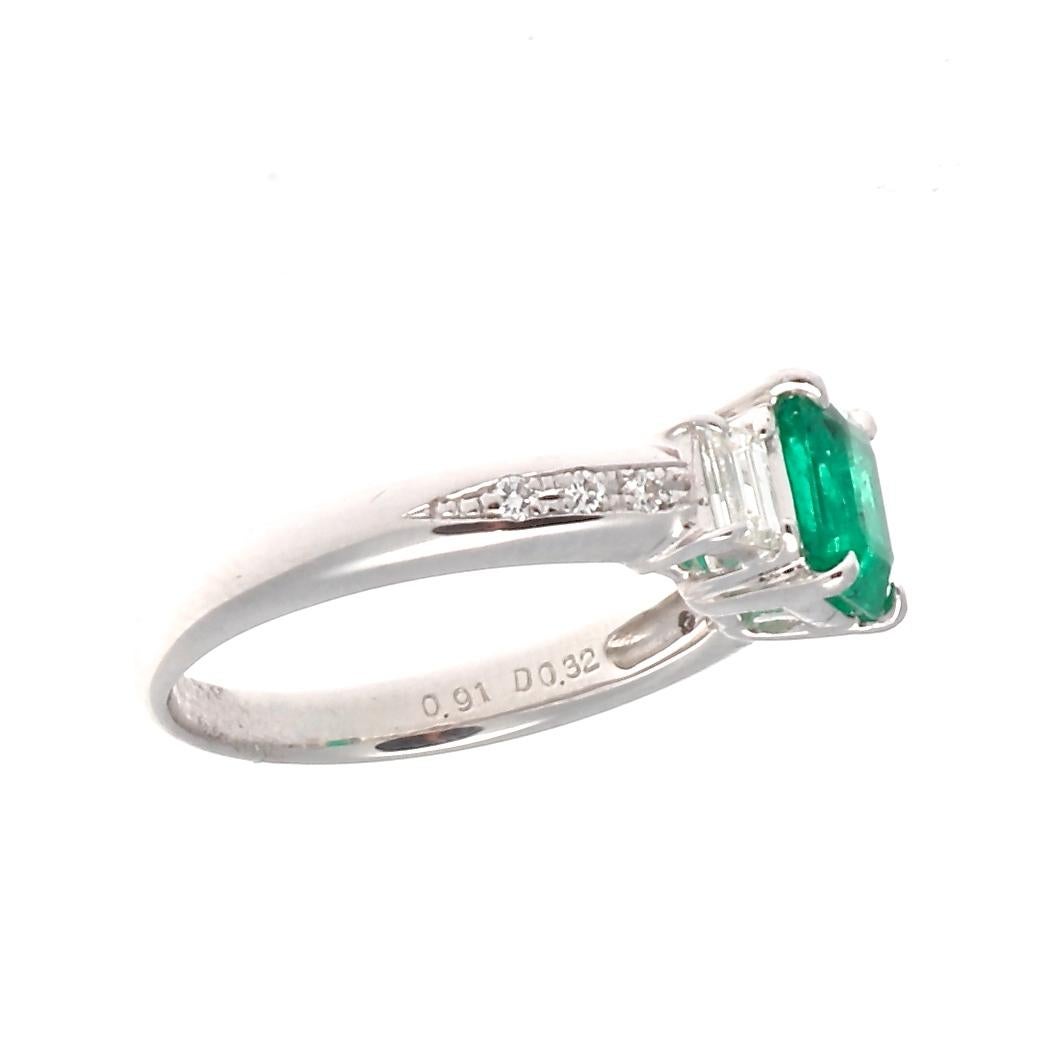 Staying true to tradition and close to peoples hearts. This colorful creation has added new temptations on how to say forever to the one you love. Featuring a 0.91 carat Colombian emerald that is exquisitely accented by trapezoidal and round cut